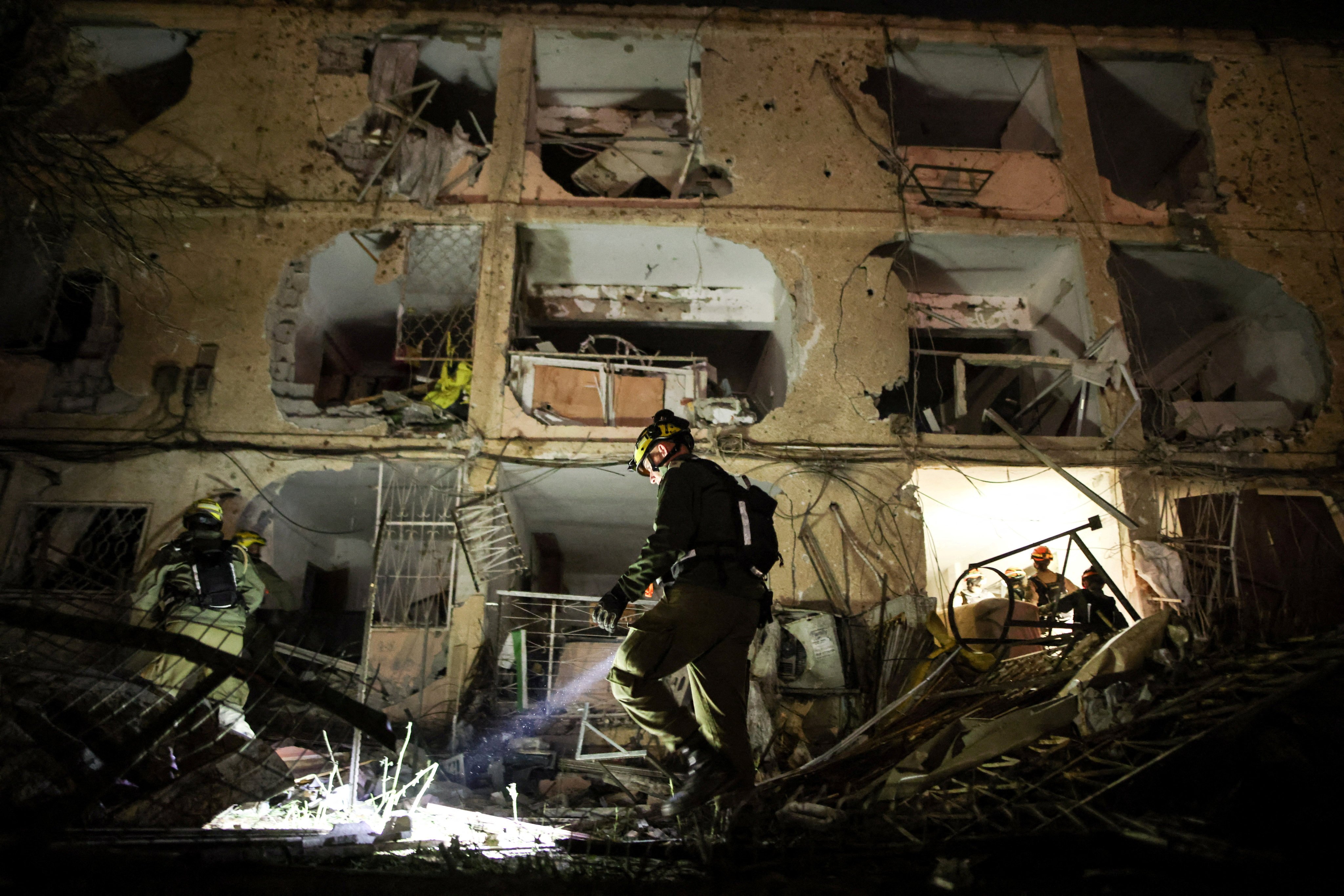 An Israeli soldier inspects the damage after Iranian missiles struck Dimona on Saturday. Photo: Reuters