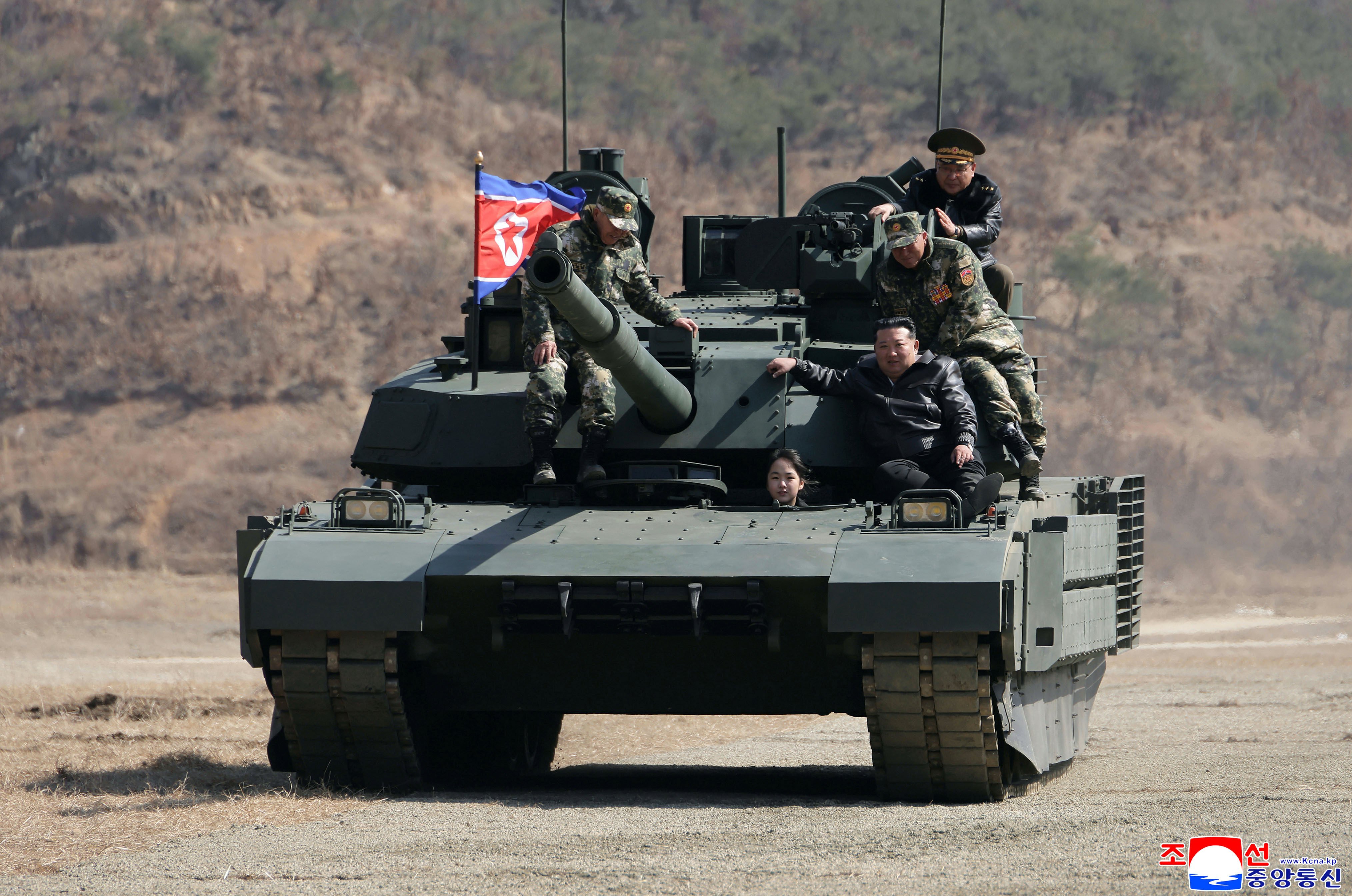 This photo provided by the North Korean government shows its leader Kim Jong Un, front right, his daughter, reportedly named Kim Ju Ae, and other soldiers on a tank at a military training base in North Korea, Thursday, March 19, 2026. Independent journalists were not given access to cover the event depicted in this image distributed by the North Korean government. The content of this image is as provided and cannot be independently verified. Korean language watermark on image as provided by source reads: "KCNA" which is the abbreviation for Korean Central News Agency. (Korean Central News Agency/Korea News Service via AP)