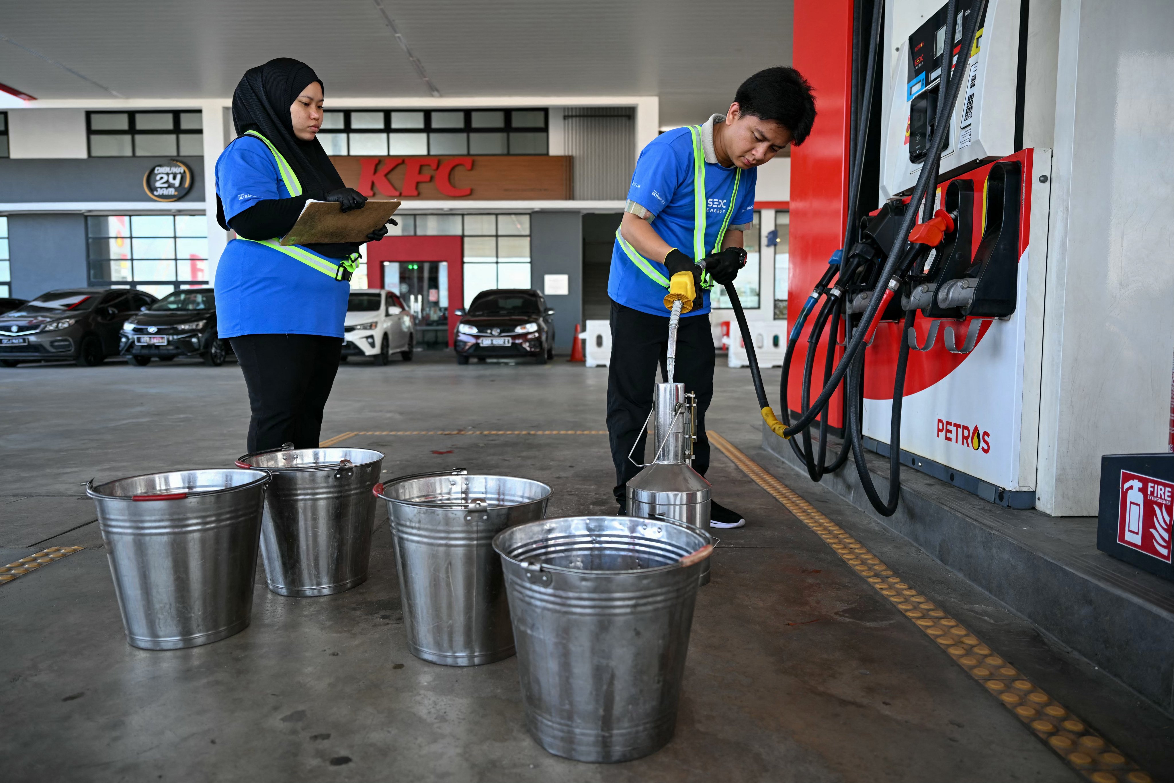 A worker pumps fuel at a petrol station in Sarawak, Malaysia. Photo: AFP
