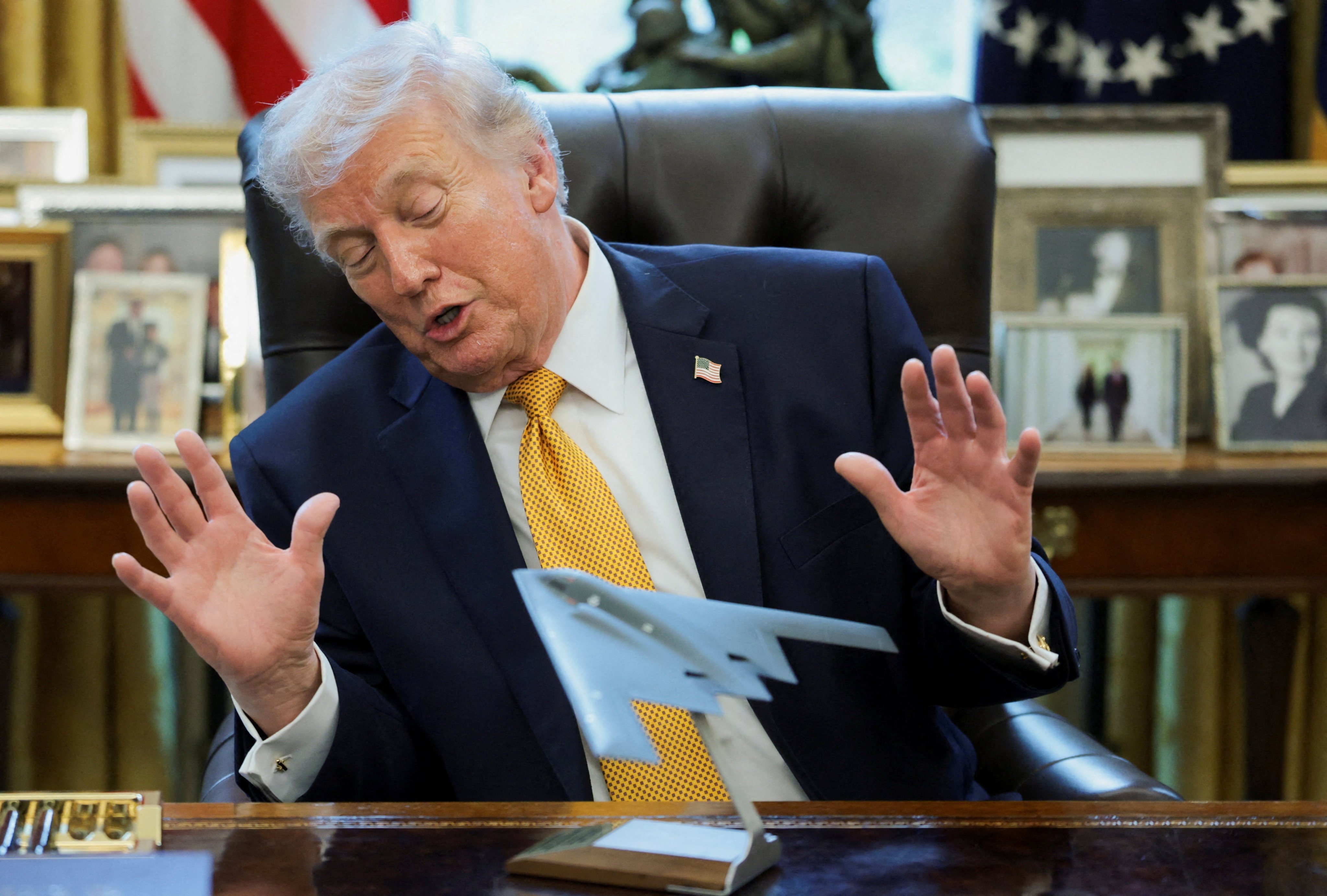 US President Donald Trump looks at a model of a B-2 bomber commemorating ‘Operation Midnight Hammer’ against Iran. Photo: Reuters