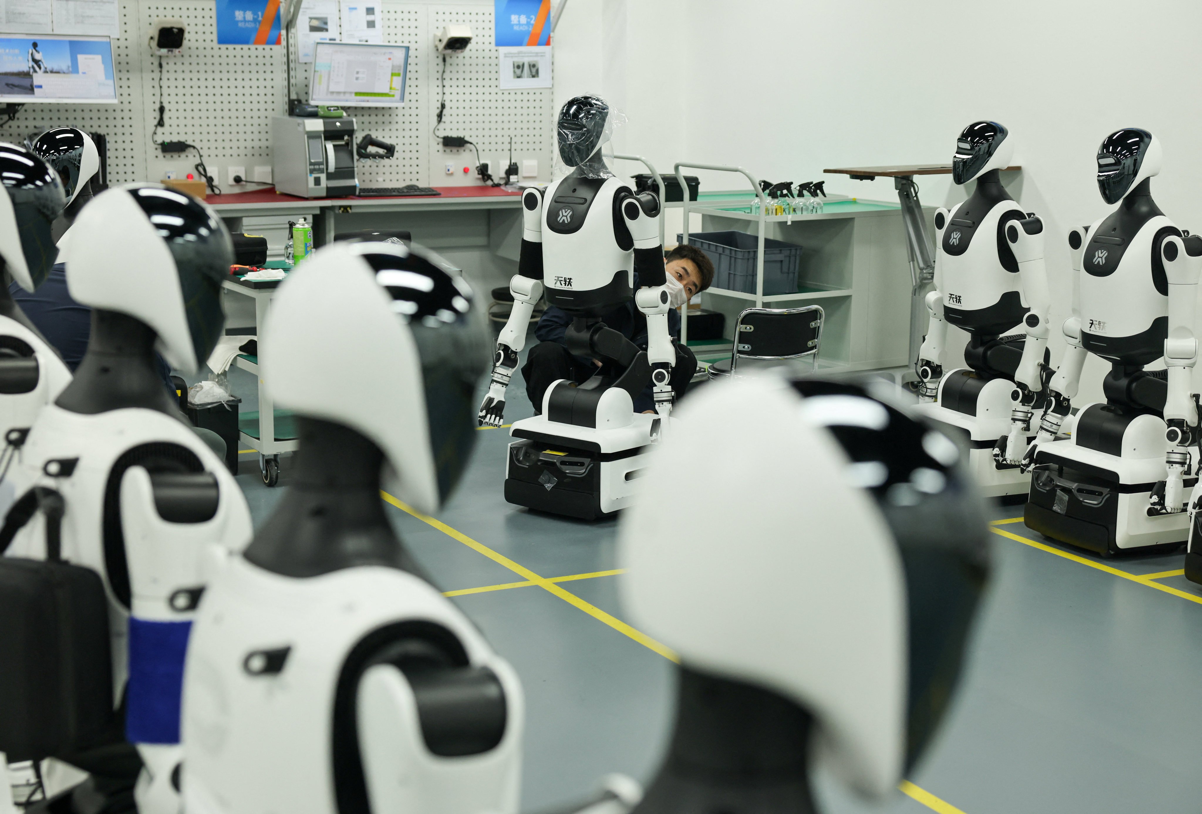 An employee assembles robots at the production line during organized media tour to the Robotics Pilot Testing and Validation Platform of Beijing Innovation Center of Humanoid Robotics (X-Humanoid) in Beijing, China, March 20, 2026. REUTERS/Maxim Shemetov