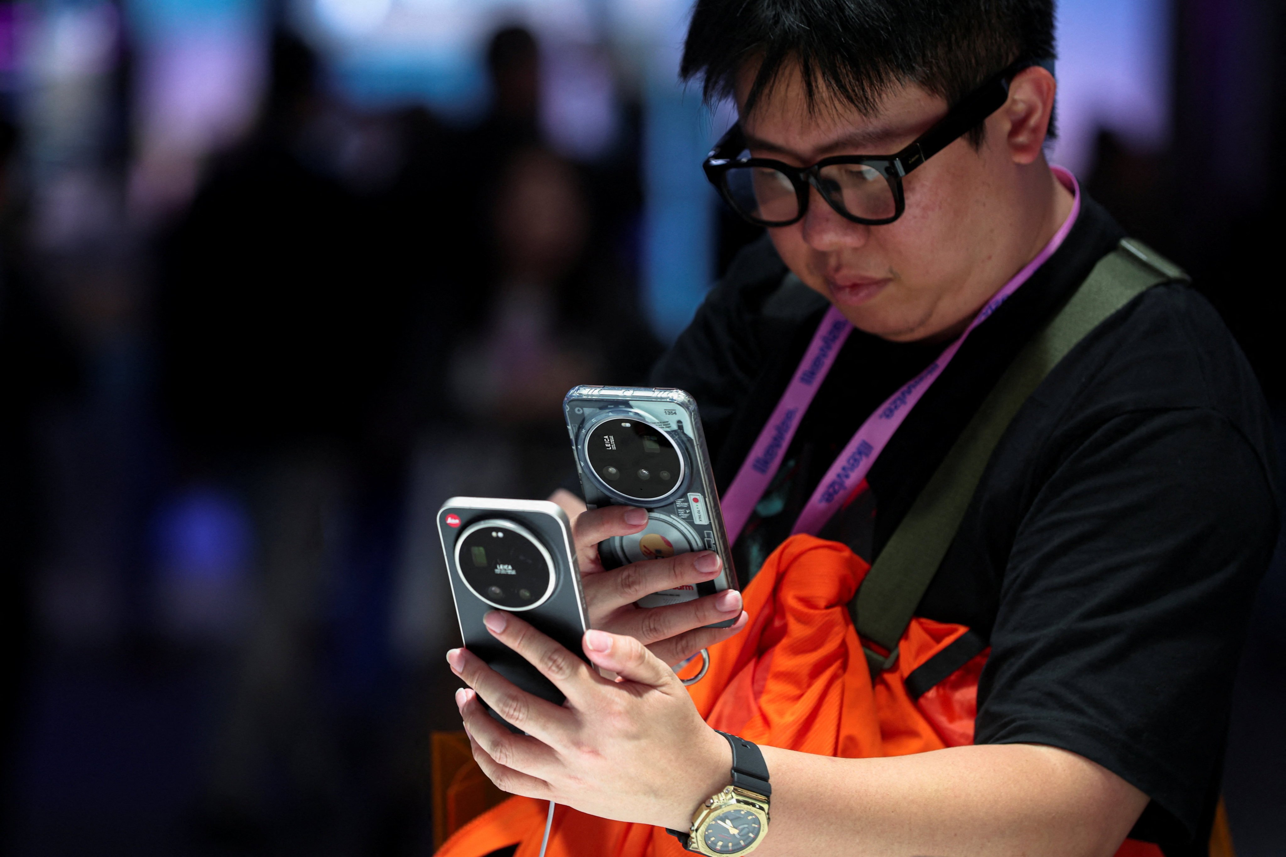 A man takes a picture of a Xiaomi phone at the Mobile World Congress in Barcelona, Spain, on March 2, 2026. Photo: Reuters