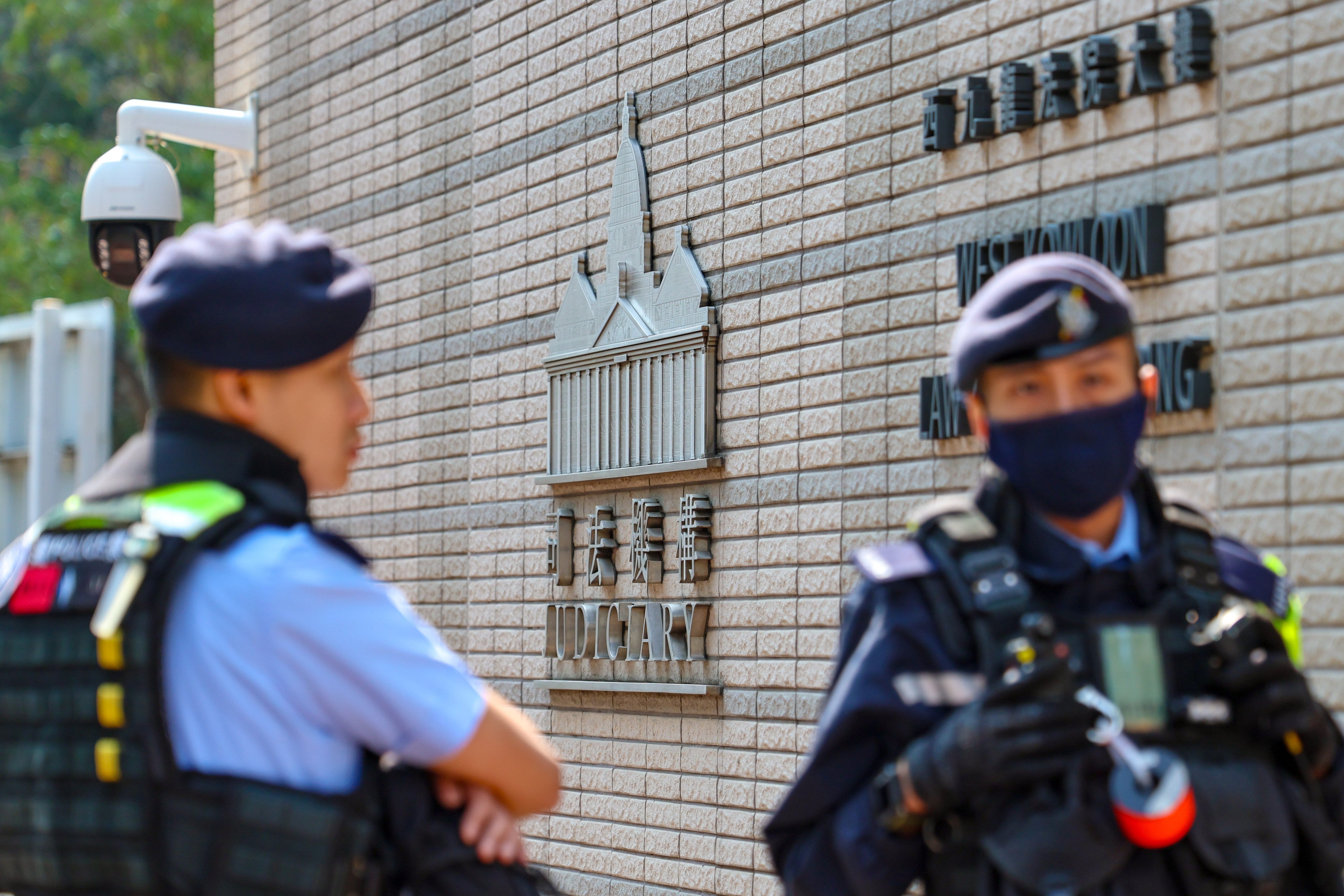 Police officers outside court in West Kowloon on February 23, on the day the Court of Appeal delivered a verdict on a case involving conspiracy to commit subversion. Photo: Dickson Lee