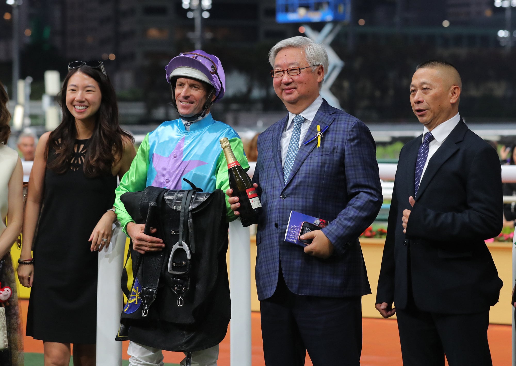 Hugh Bowman (second left) and Danny Shum (right) celebrating Joyful Prosperity's victory.