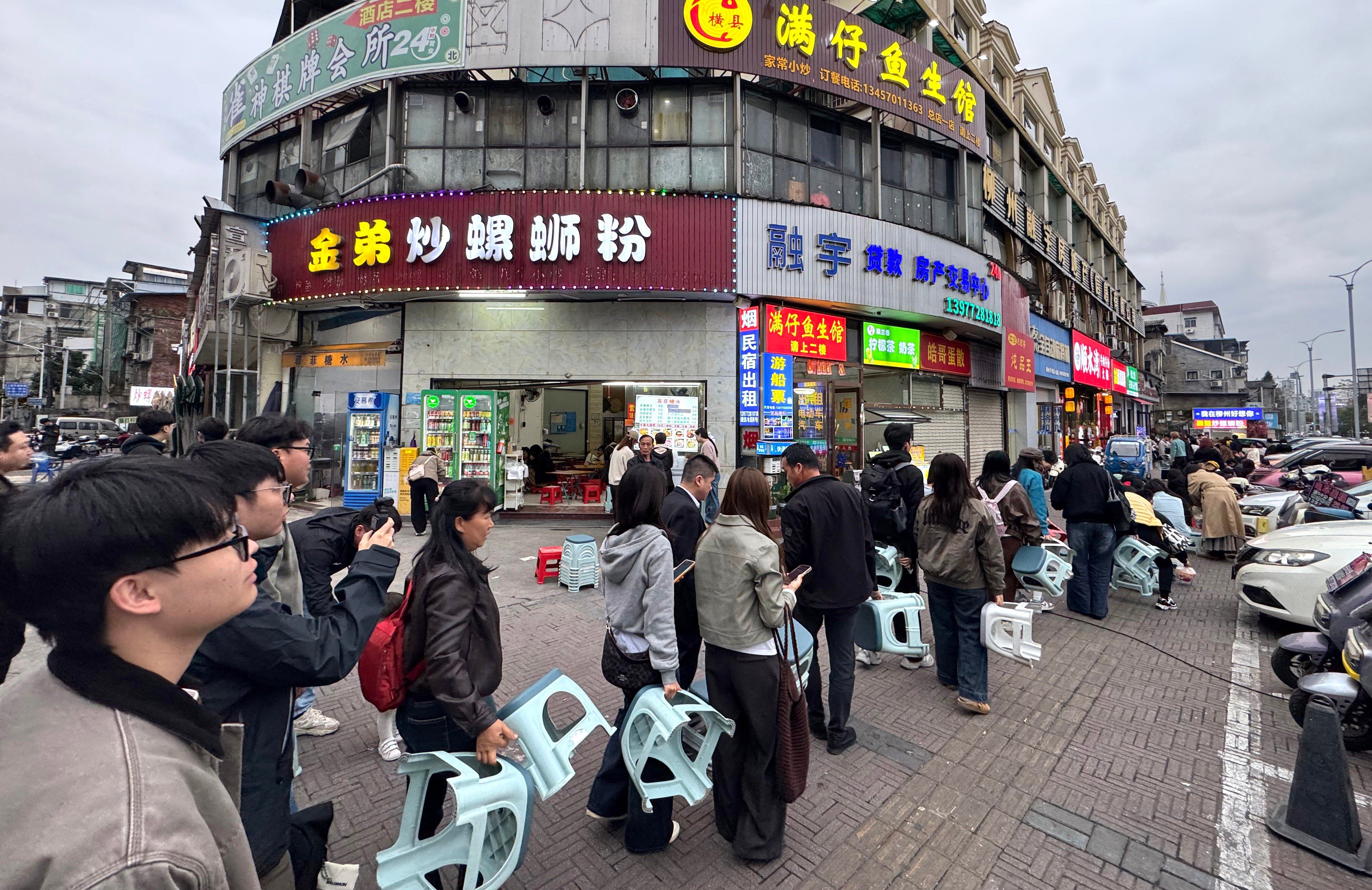 People queue to enter a shop in Liuzhou city, Guangxi Zhuang Autonomous Region, on March 10. Photo: Xinhua