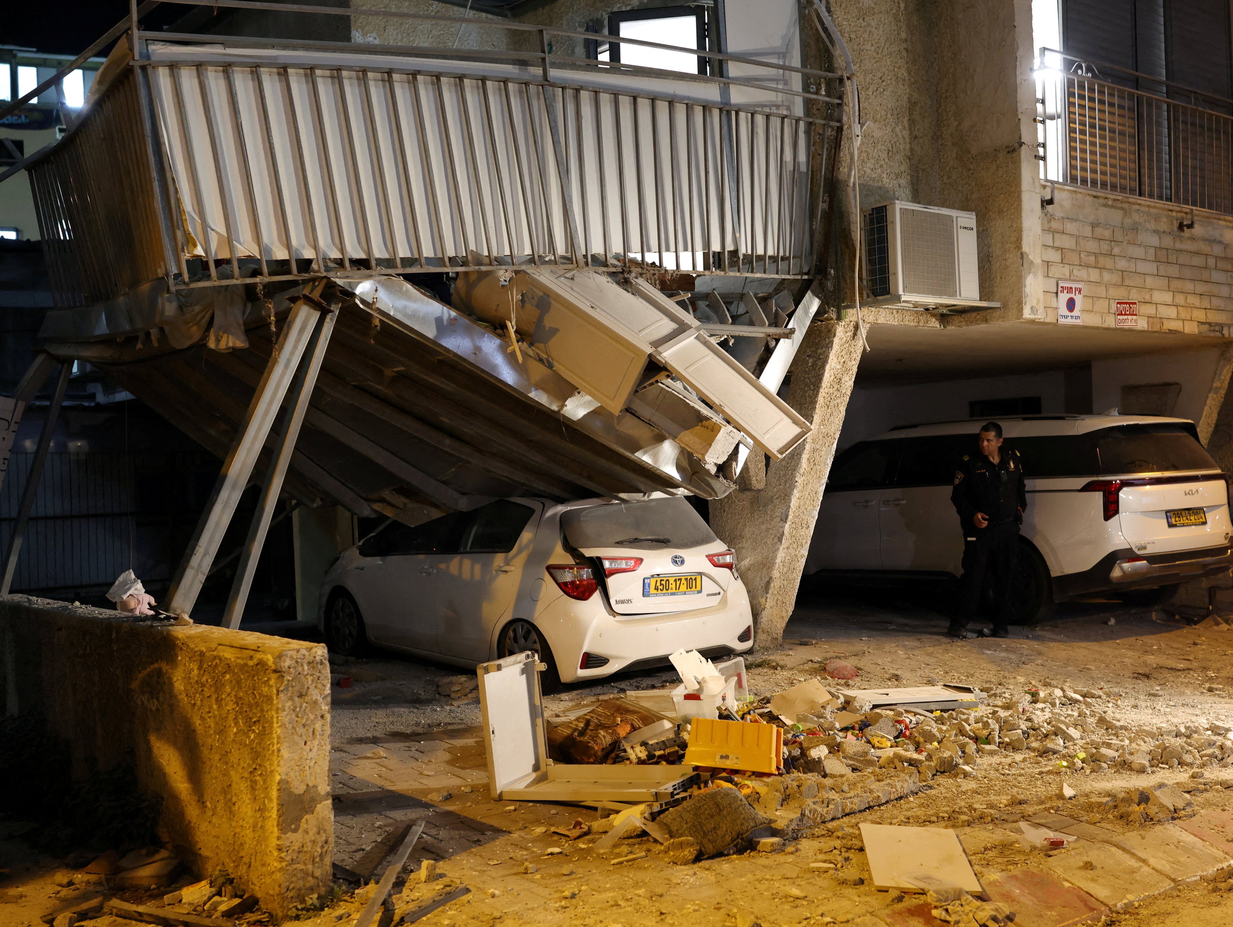 A first responder looks at damage following Iranian missile barrages in central Israel. Photo: Reuters