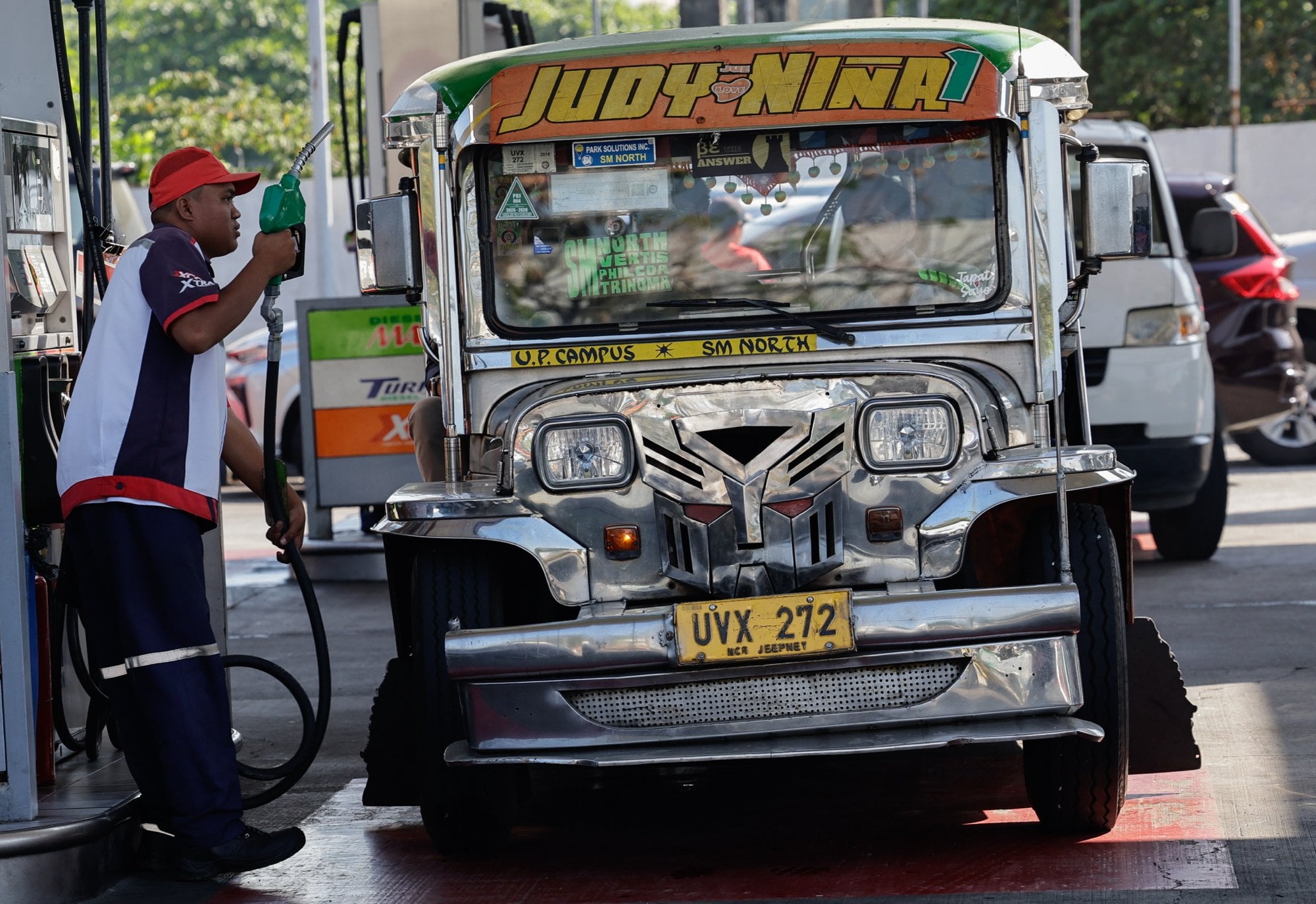 A fuel station worker prepares to refuel a jeepney, or local minibus, in Quezon City, the Philippines, on Wednesday. Photo: EPA