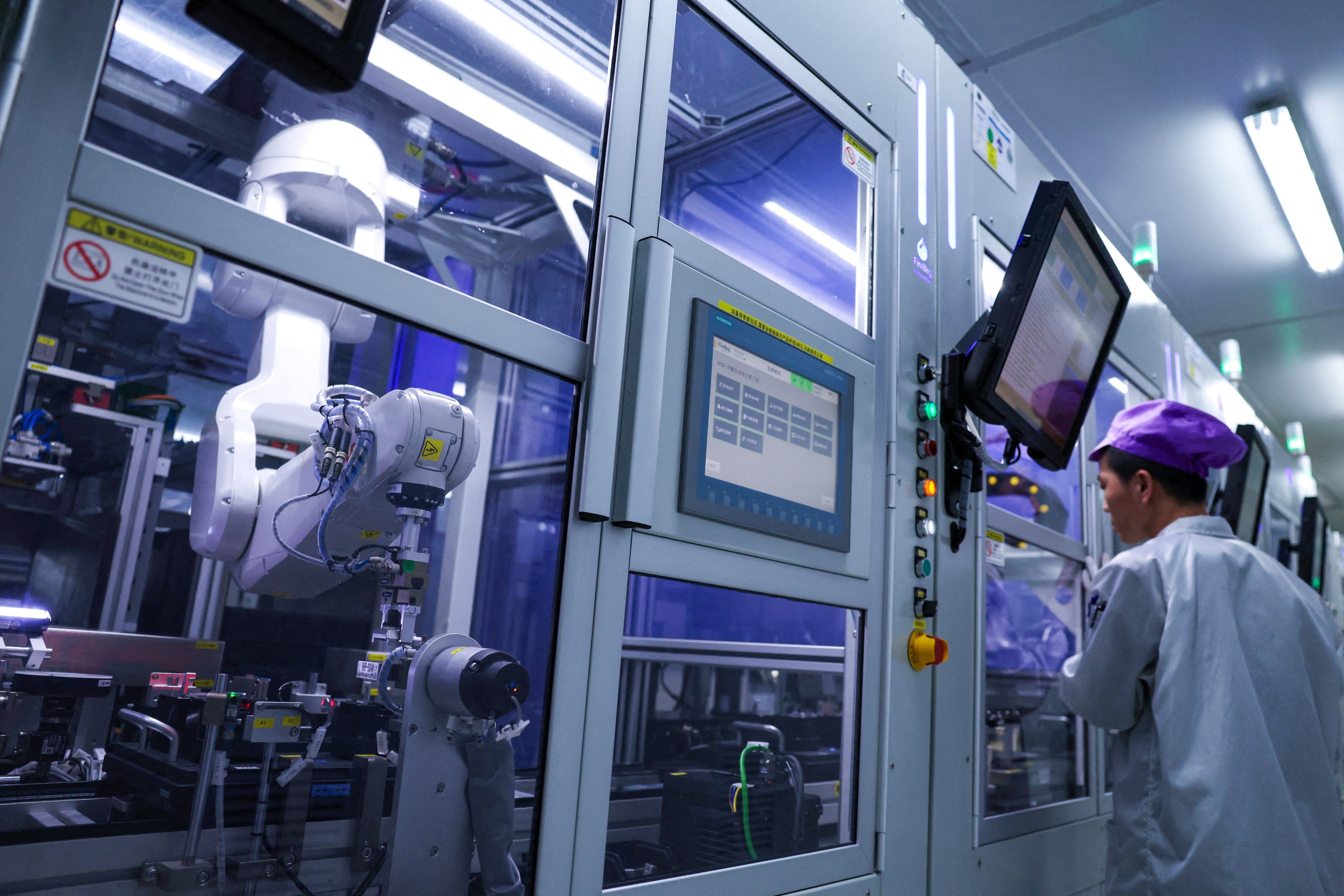 A robotic arm operates on an autonomous production line in Shenzhen. Photo: Reuters