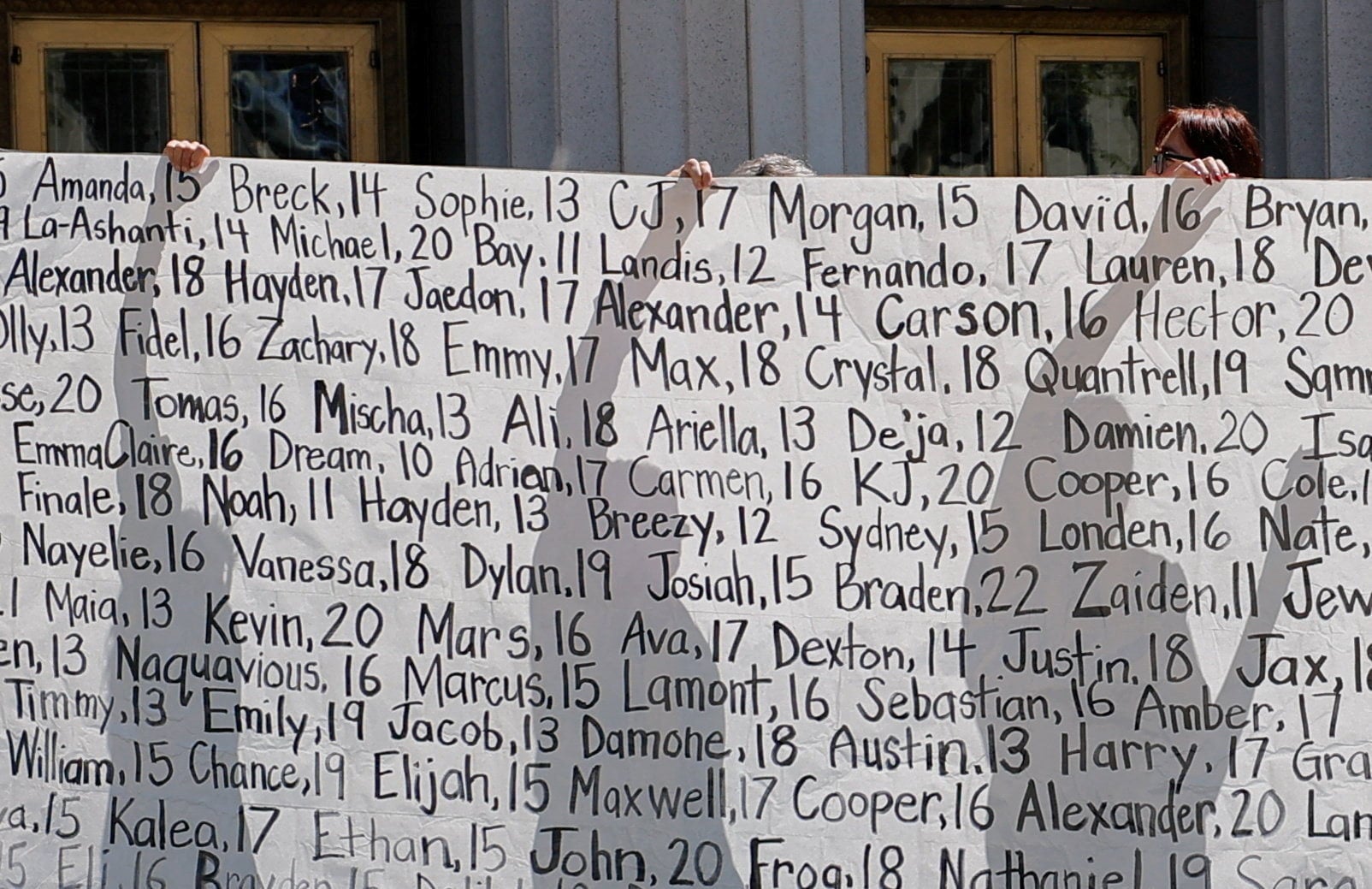 Parents who say they have lost their children due to social media hold up a banner with names outside the court. Photo: Reuters