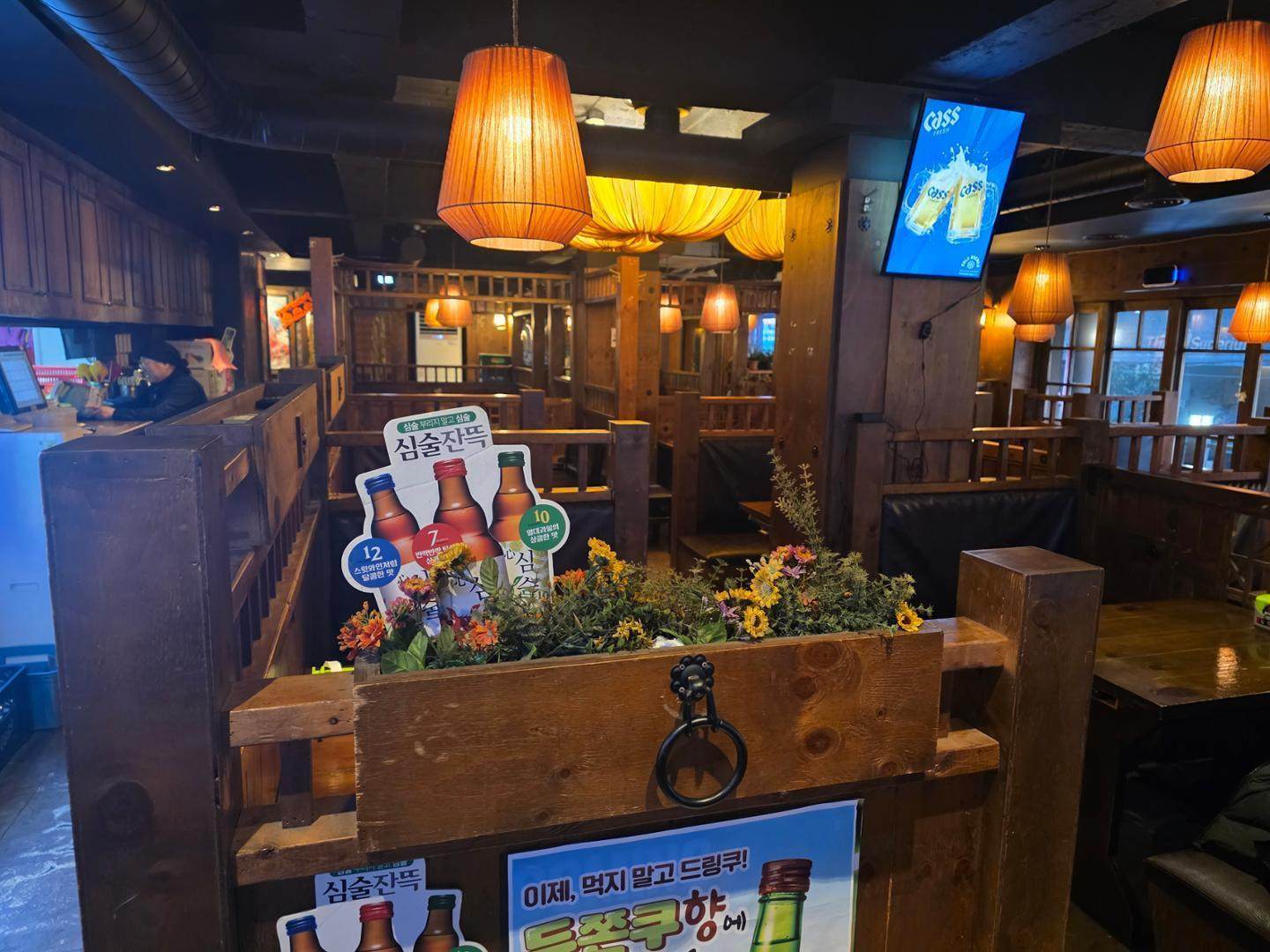 Empty tables are seen behind alcohol promotional displays at a bar near Seoul National University in South Korea. Photo: Korea Times