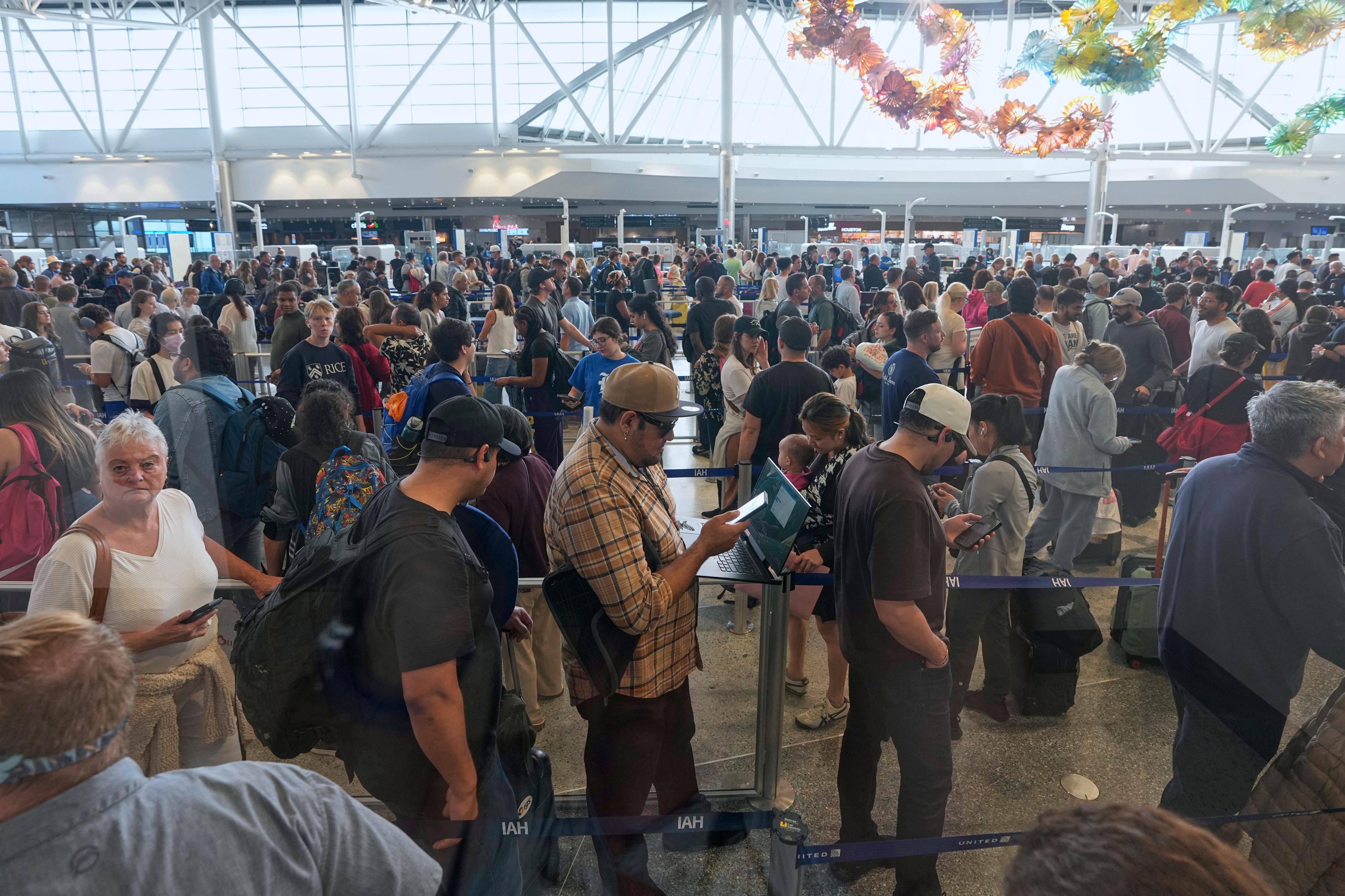 Passengers wait in a security checkpoint line at George Bush Intercontinental Airport in Houston. Photo: AP