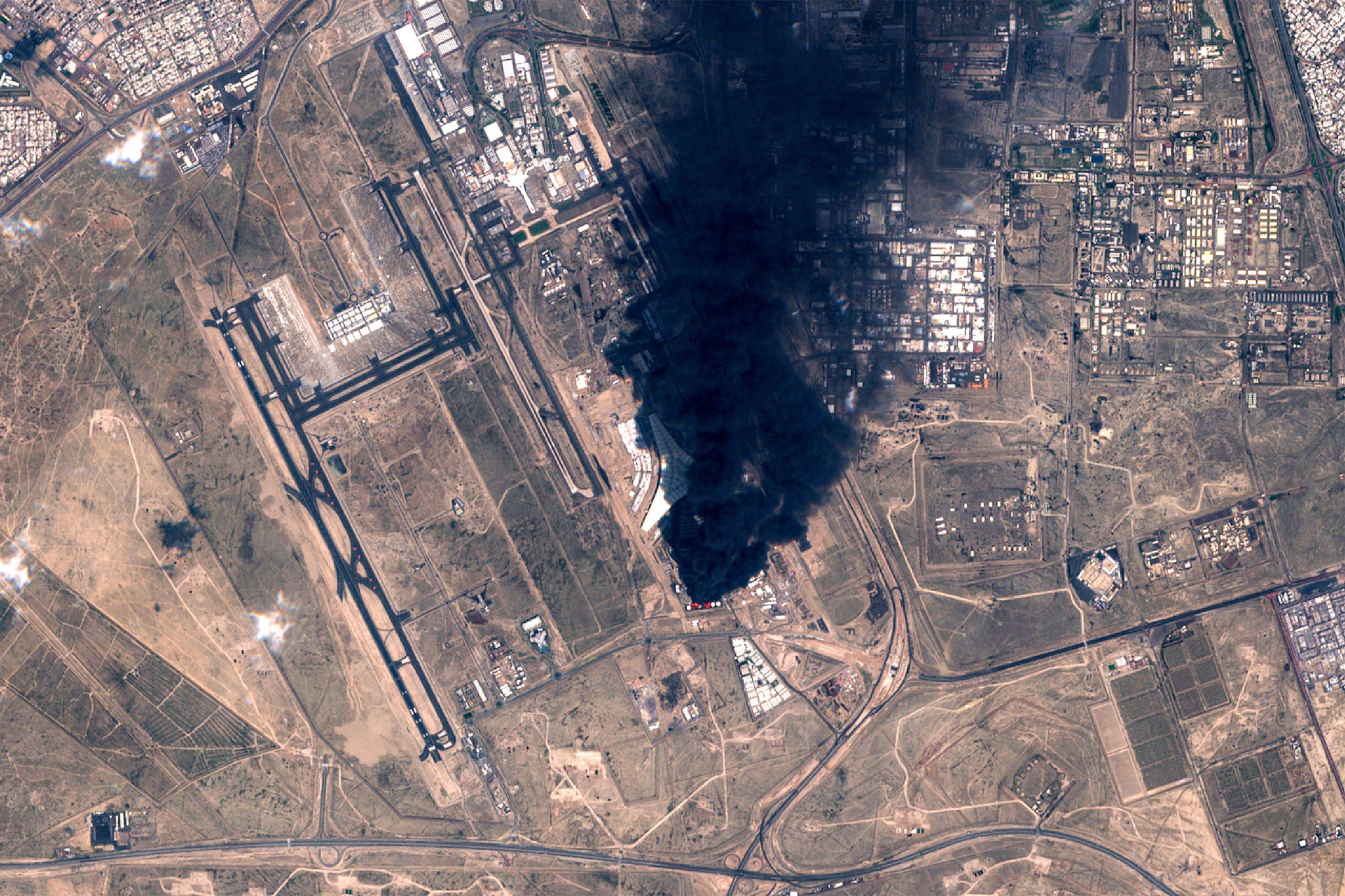 Smoke plumes billowing in the vicinity of Kuwait International Airport on Wednesday after drones hit a fuel tank and sparked a fire. Photo: European Space Agency via AFP