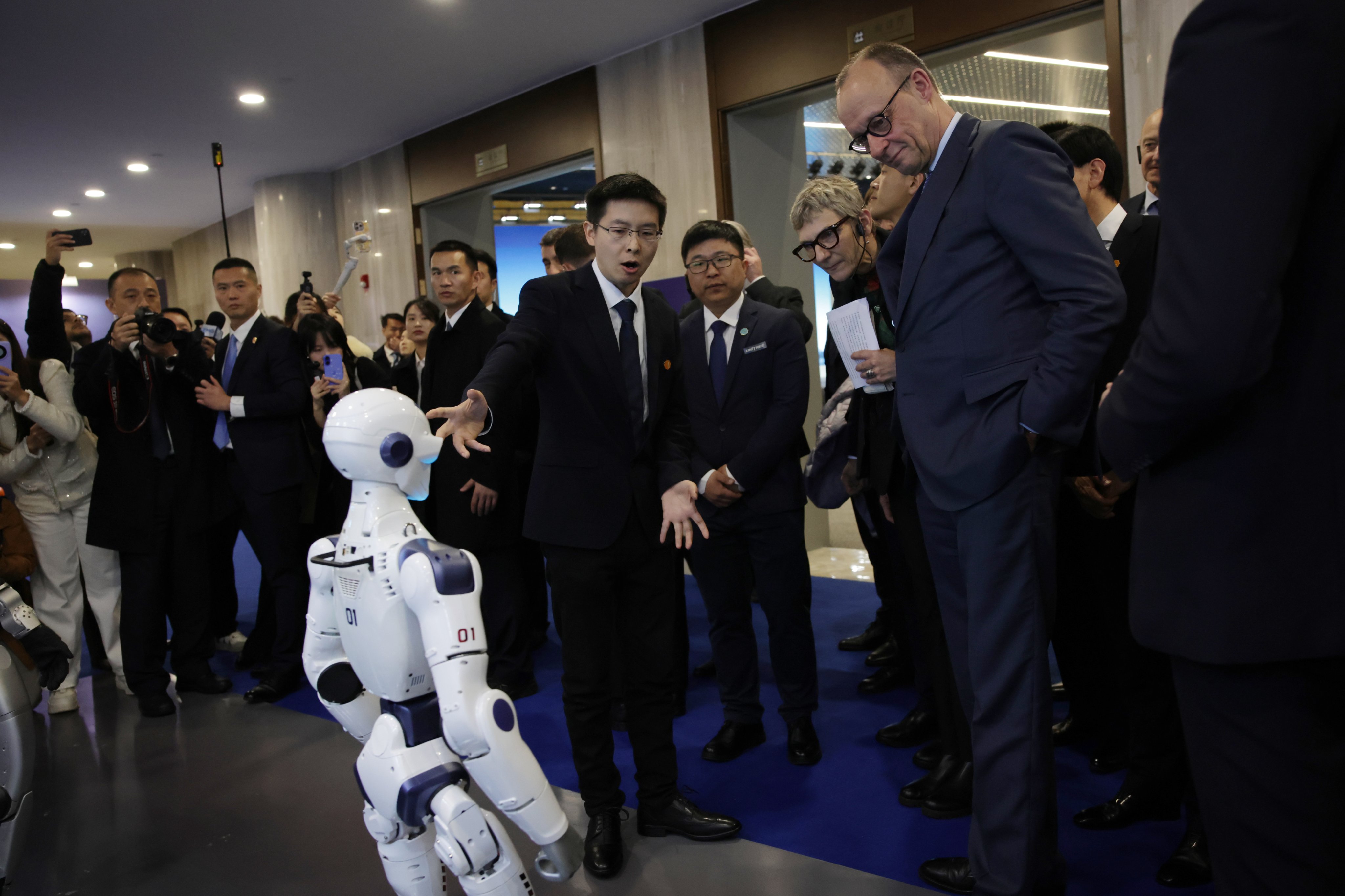 German Chancellor Friedrich Merz (right) visited Unitree’s headquarters in Hangzhou last month. (Photo: EPA)