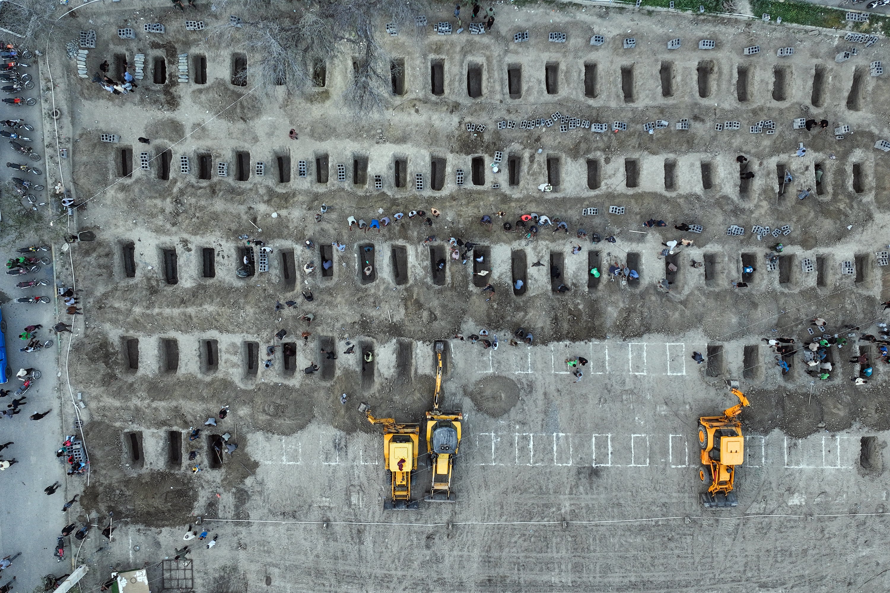 Mourners dig graves during the funeral for children killed in a US-Israeli strike on a school in Minab, Iran, on March 3. Photo: Iranian Press Centre/AFP/Getty Images/TNS