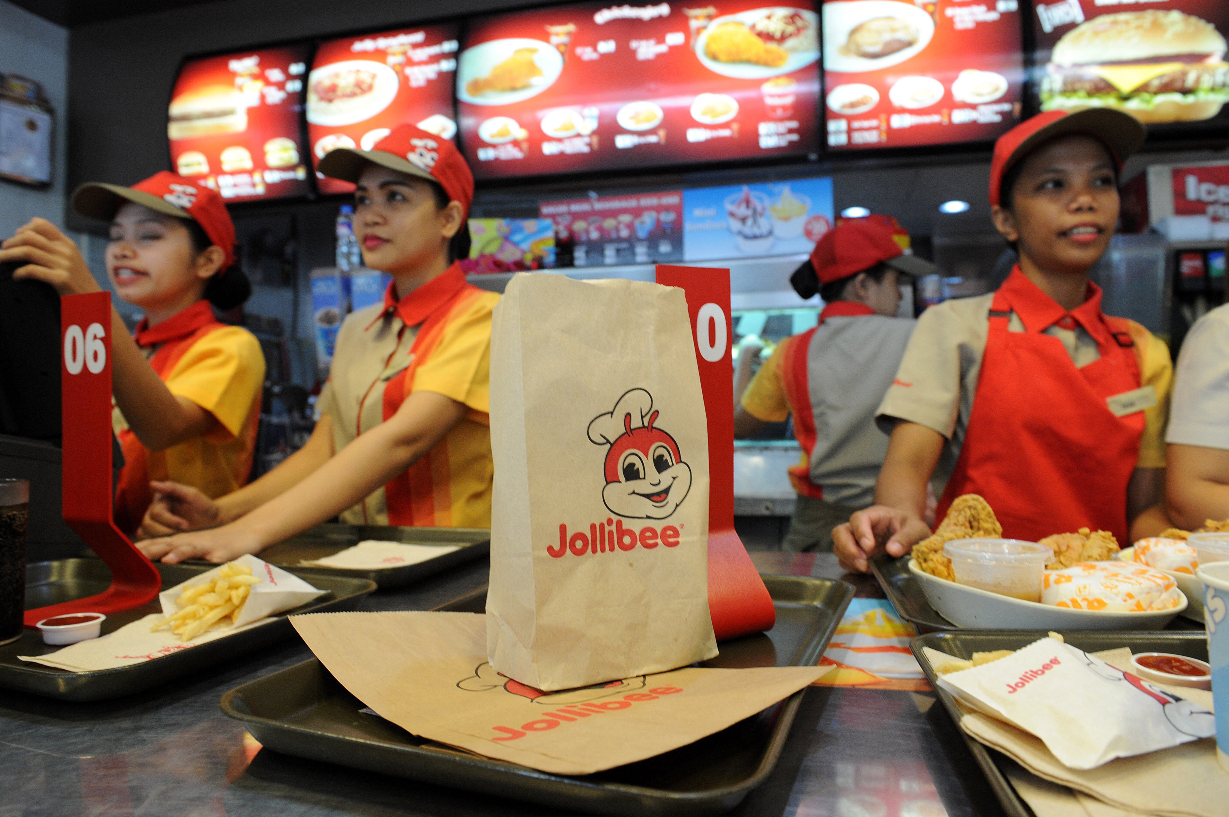 Jollibee employees attend to customers at an outlet in Manila in 2015. Photo: AFP