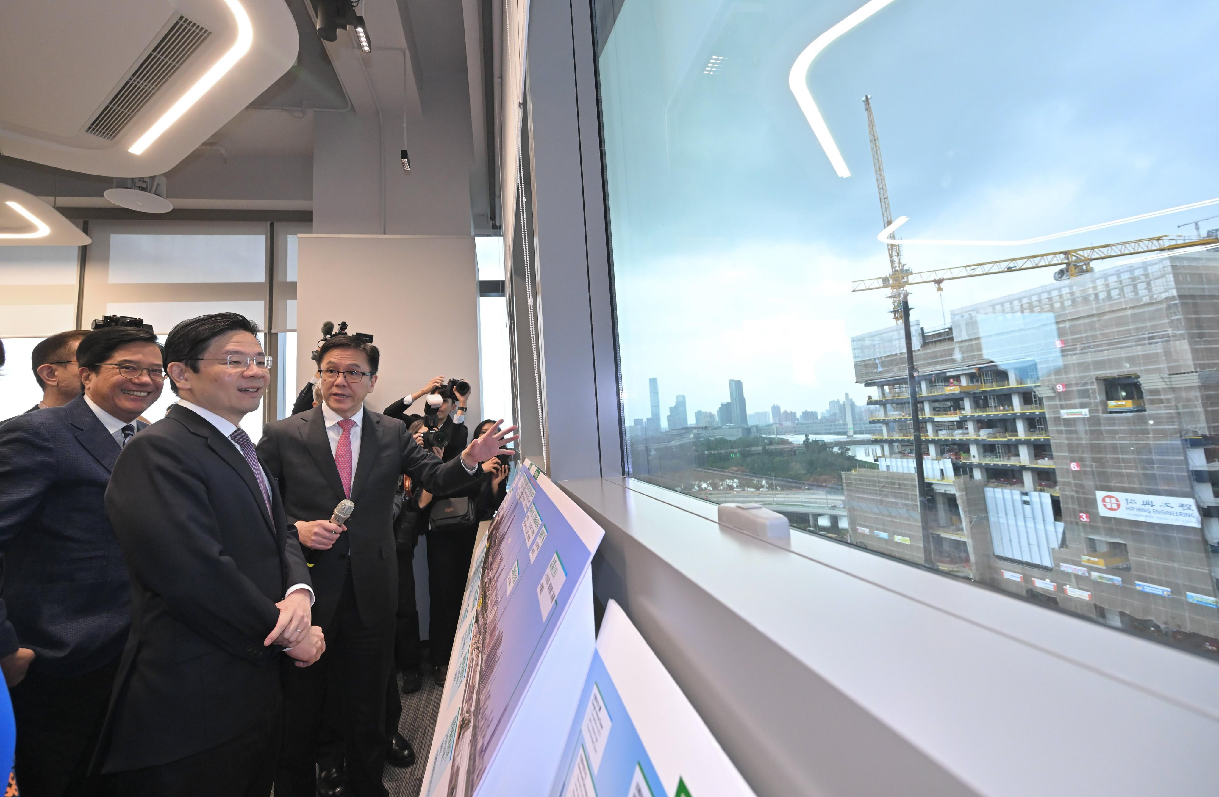 Prime Minister Lawrence Wong (second left) is briefed by Secretary for Innovation, Technology and Industry Sun Dong (third left) during his visit to the Hong Kong park in the Hetao cooperation zone. Photo: Handout