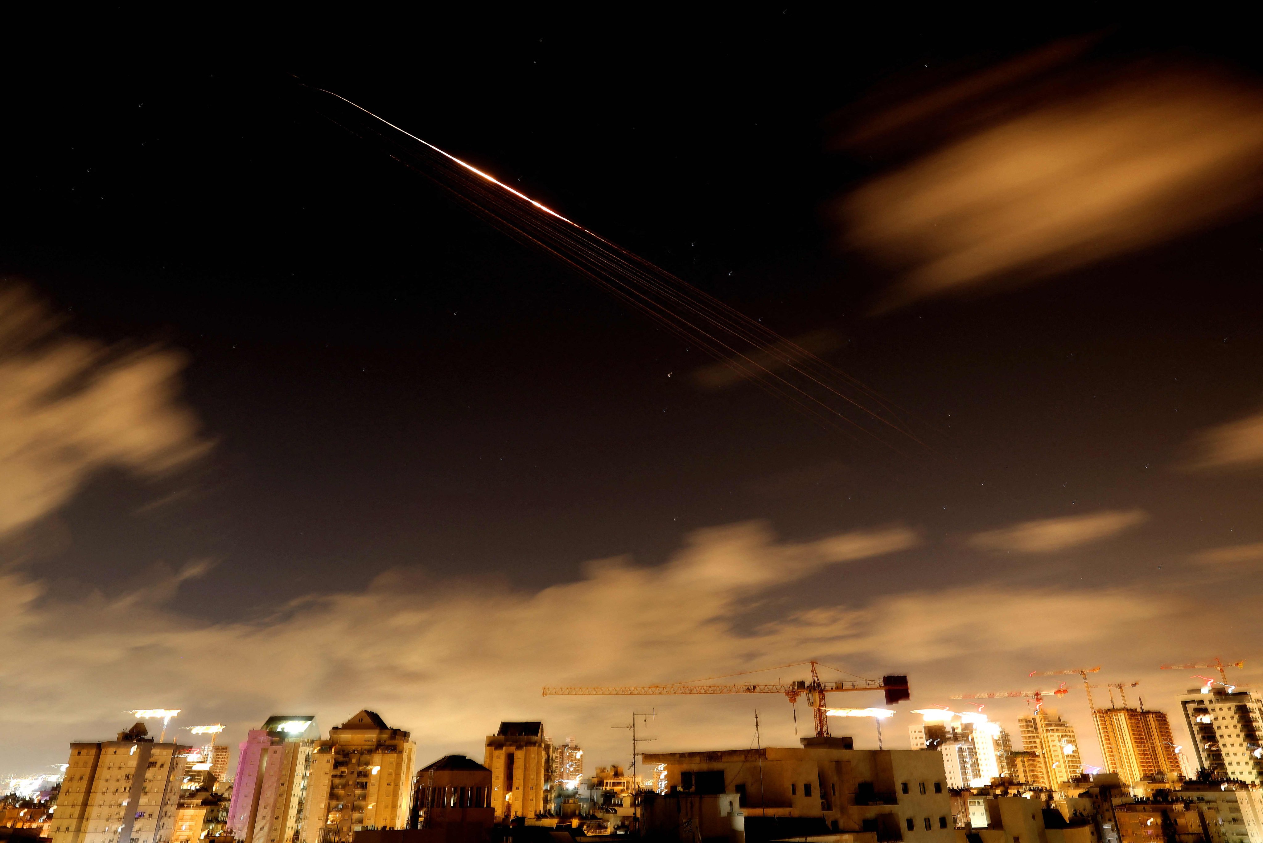 Rocket trails are seen in the sky amid a fresh barrage of Iranian missile attacks above the Israeli coastal city of Netanya on Friday. Photo: AFP
