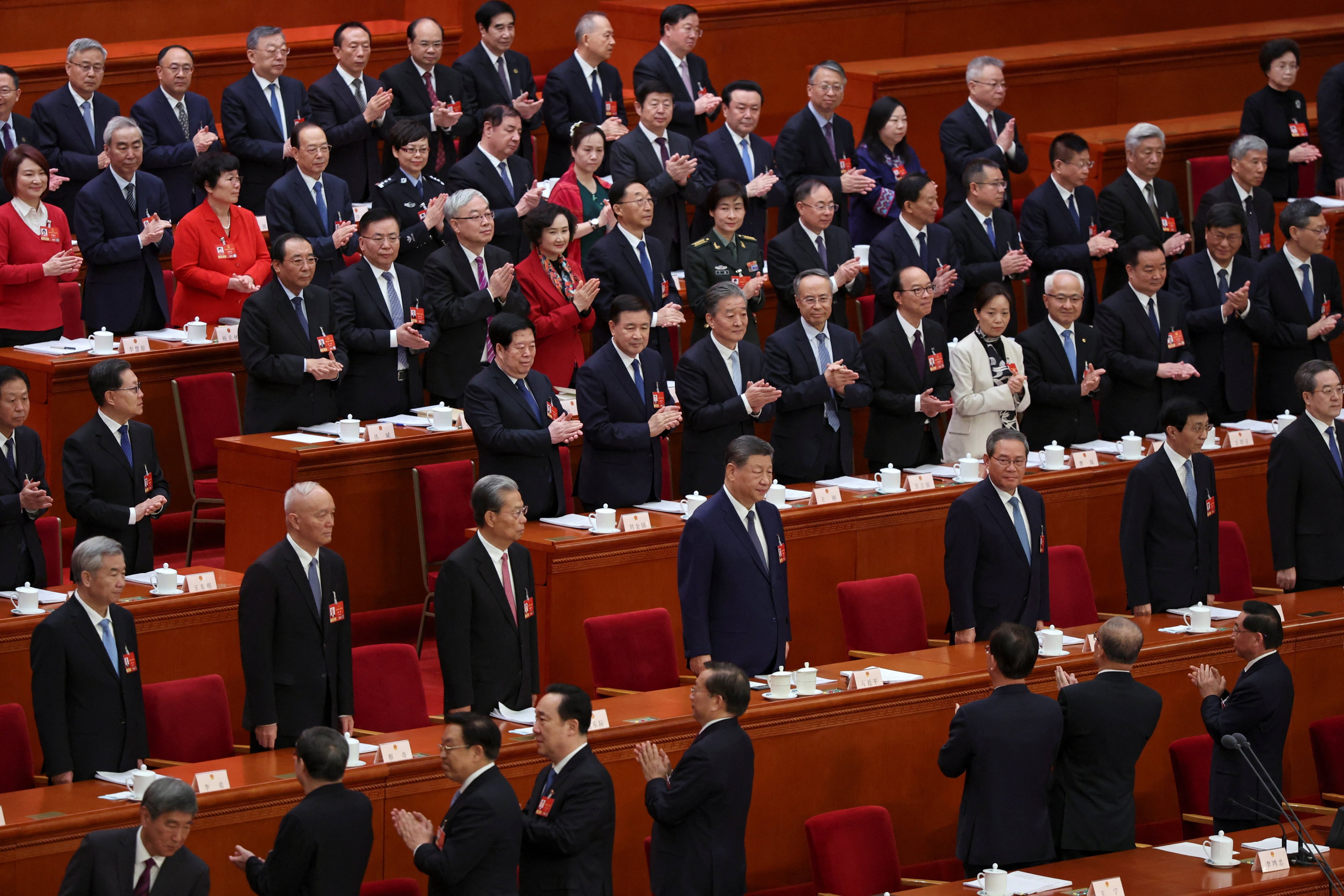 Delegates applaud as Chinese President Xi Jinping and other members of the Politburo arrive for a meeting of the National People’s Congress at the Great Hall of the People in Beijing on March 9. Photo: Reuters