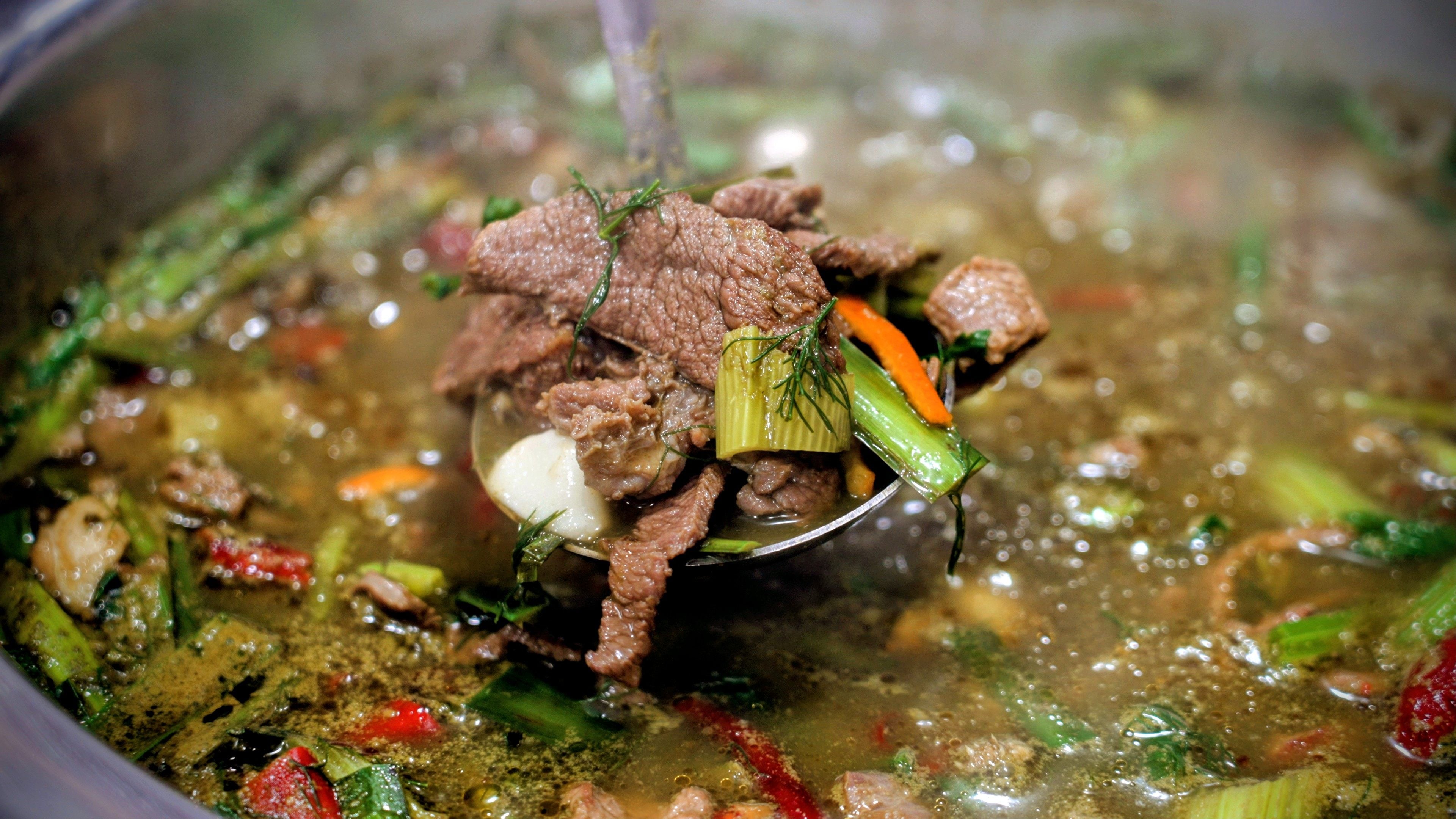 A ladle of Guizhou’s famous cow dung hotpot in the Rong Jiang Niu Bie Huo Wo Dian restaurant in Zunyi city. The dish’s ingredients include bile and undigested grass from a cow’s stomach and intestines. Photo: Llewellyn Cheung