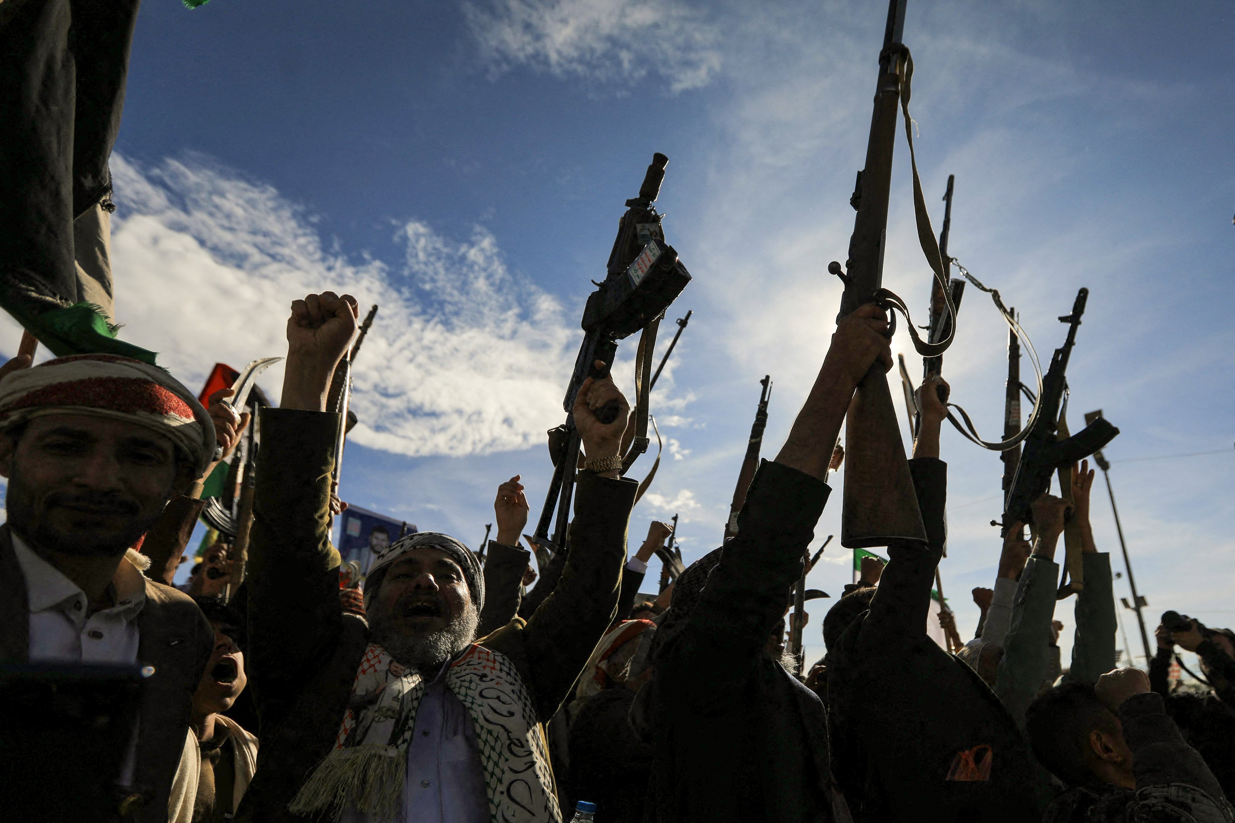 Houthis brandish their weapons as they rally in solidarity with Iran and Lebanon, amid the US-Israeli war with Iran, in the Yemeni capital Sanaa on Friday. Photo: AFP