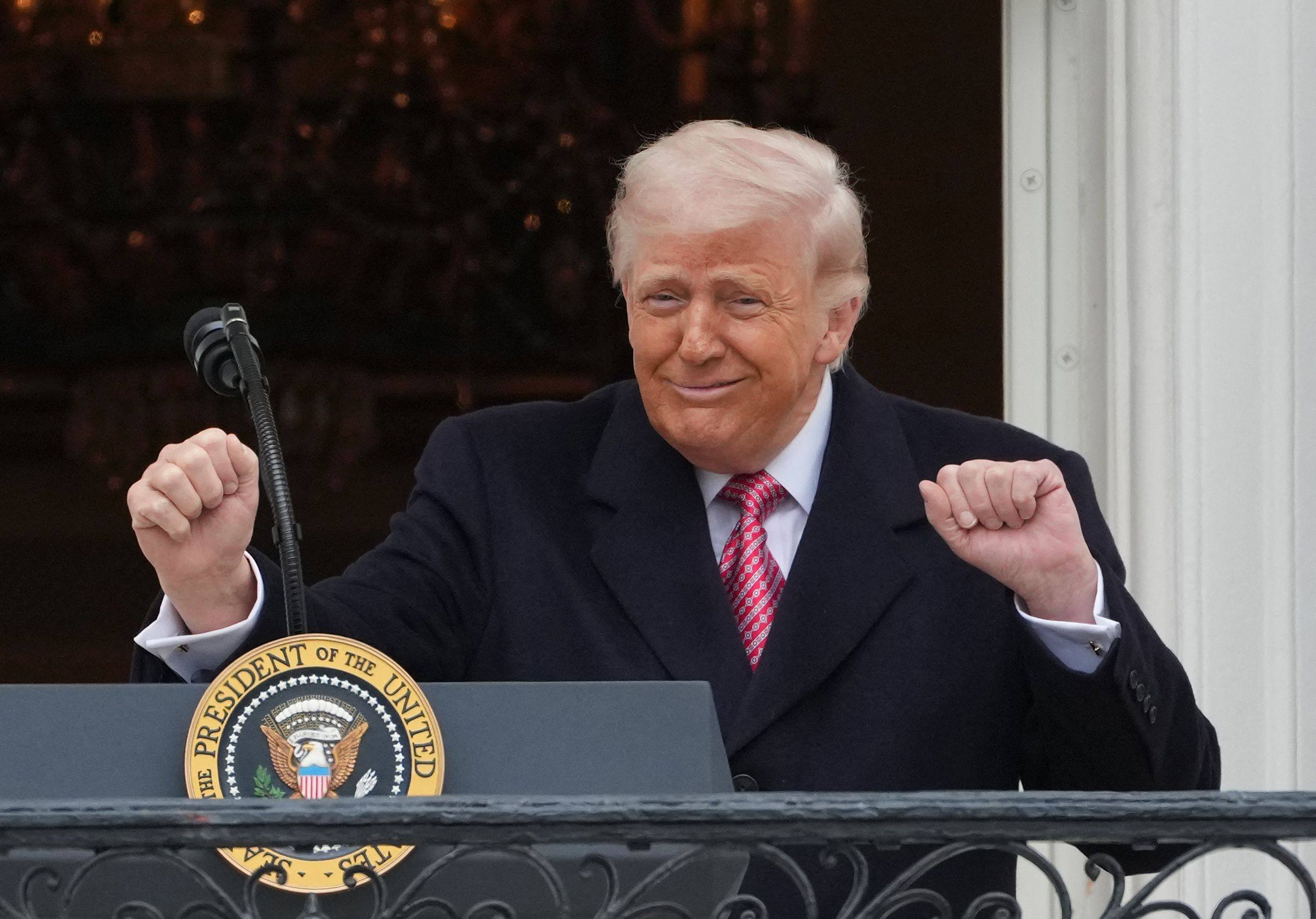 US President Donald Trump gestures to farmers from the Truman balcony of the White House in Washington on Friday. Photo: AFP