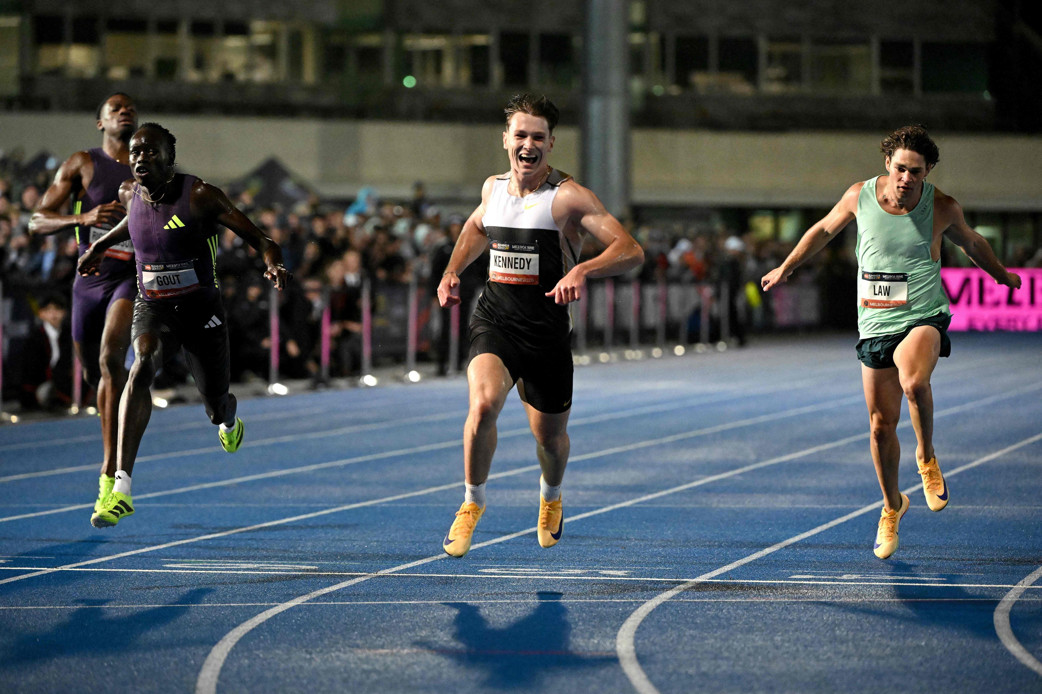 Lachlan Kennedy (centre) crosses the finish line to win the men’s 200m event just ahead of rival Gout Gout (left) at the Maurie Plant Athletics Meet in Melbourne on Saturday. Photo: AFP
