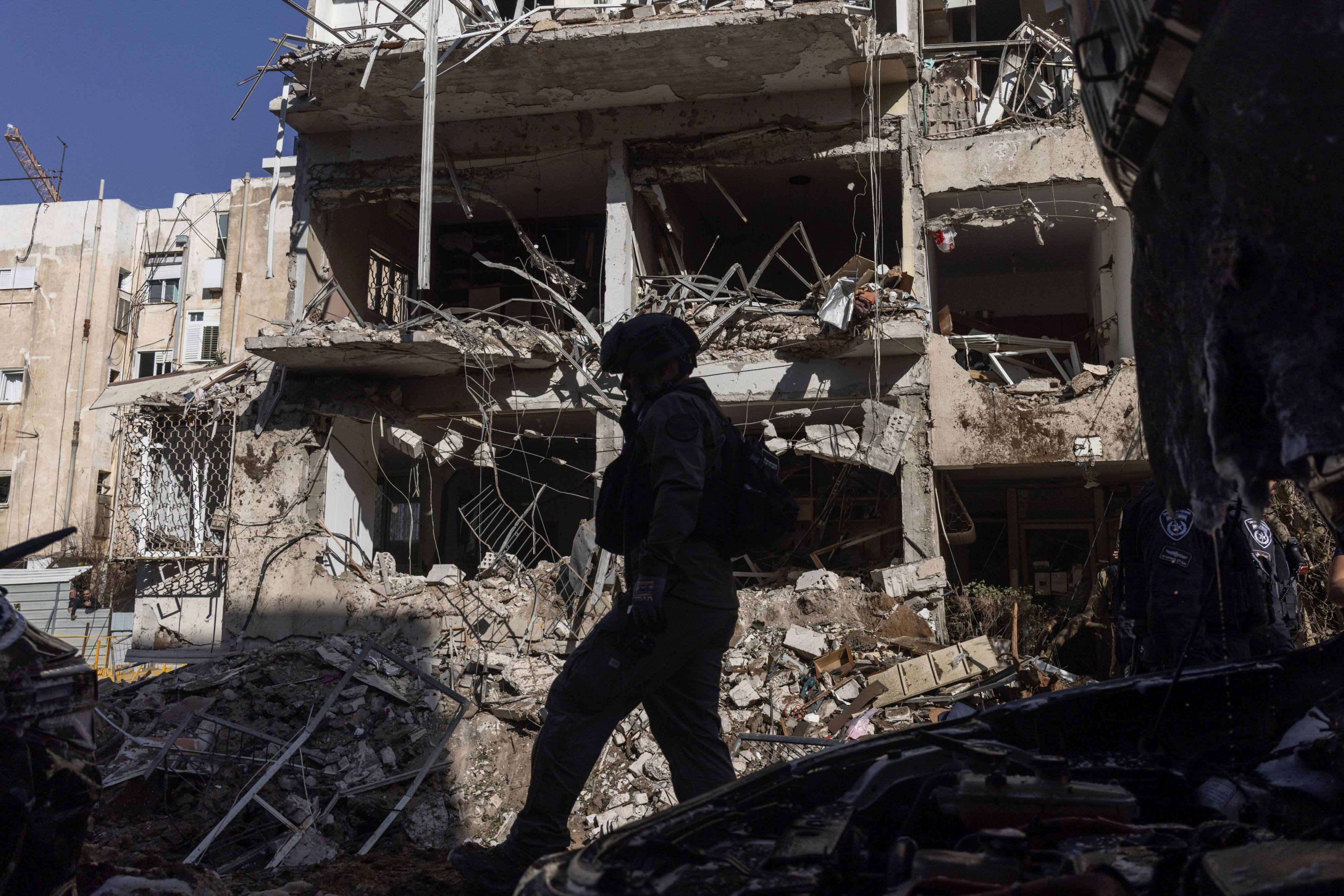 An Israeli soldier walks on the rubble caused by an Iranian missile strike on Tel Aviv, Israel, on March 24. Photo: dpa