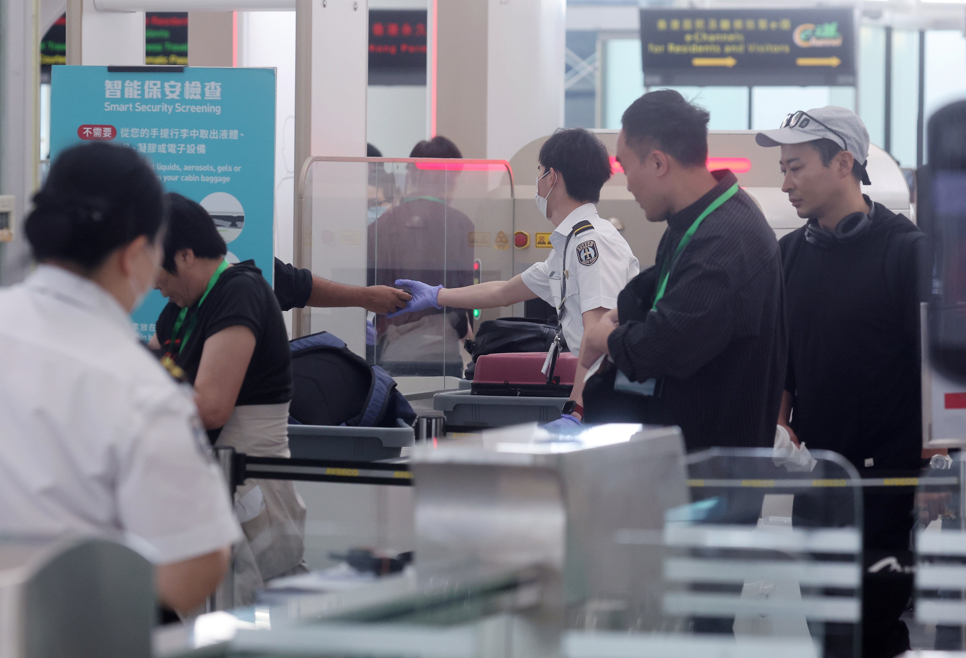 Airport Authority security check officers scan passenger baggage at Hong Kong International Airport in Chek Lap Kok on March 29. Photo: Edmond So