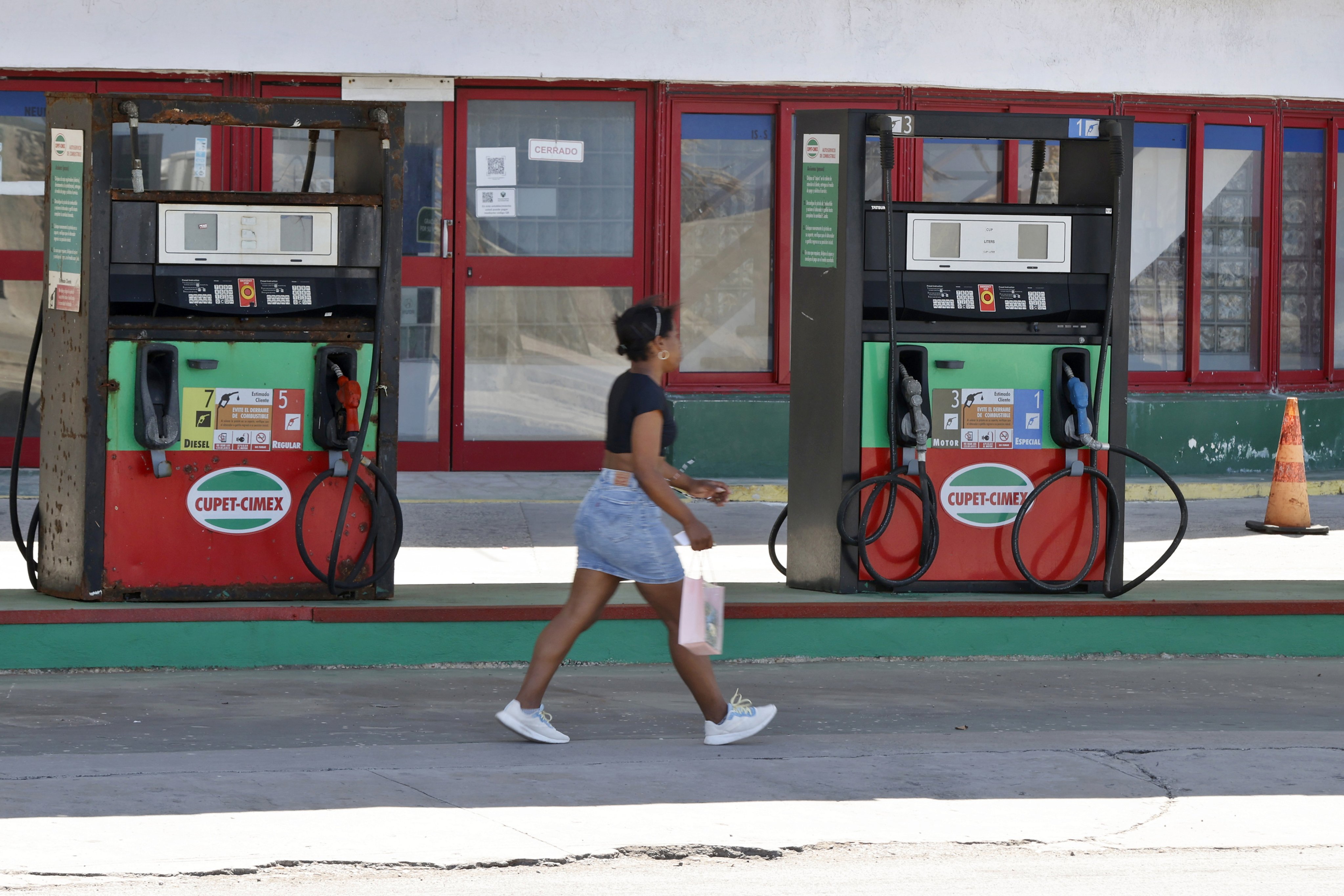 A person walks past a petrol station in Havana, Cuba amid a fuel crisis on the Caribbean island. Photo: EPA