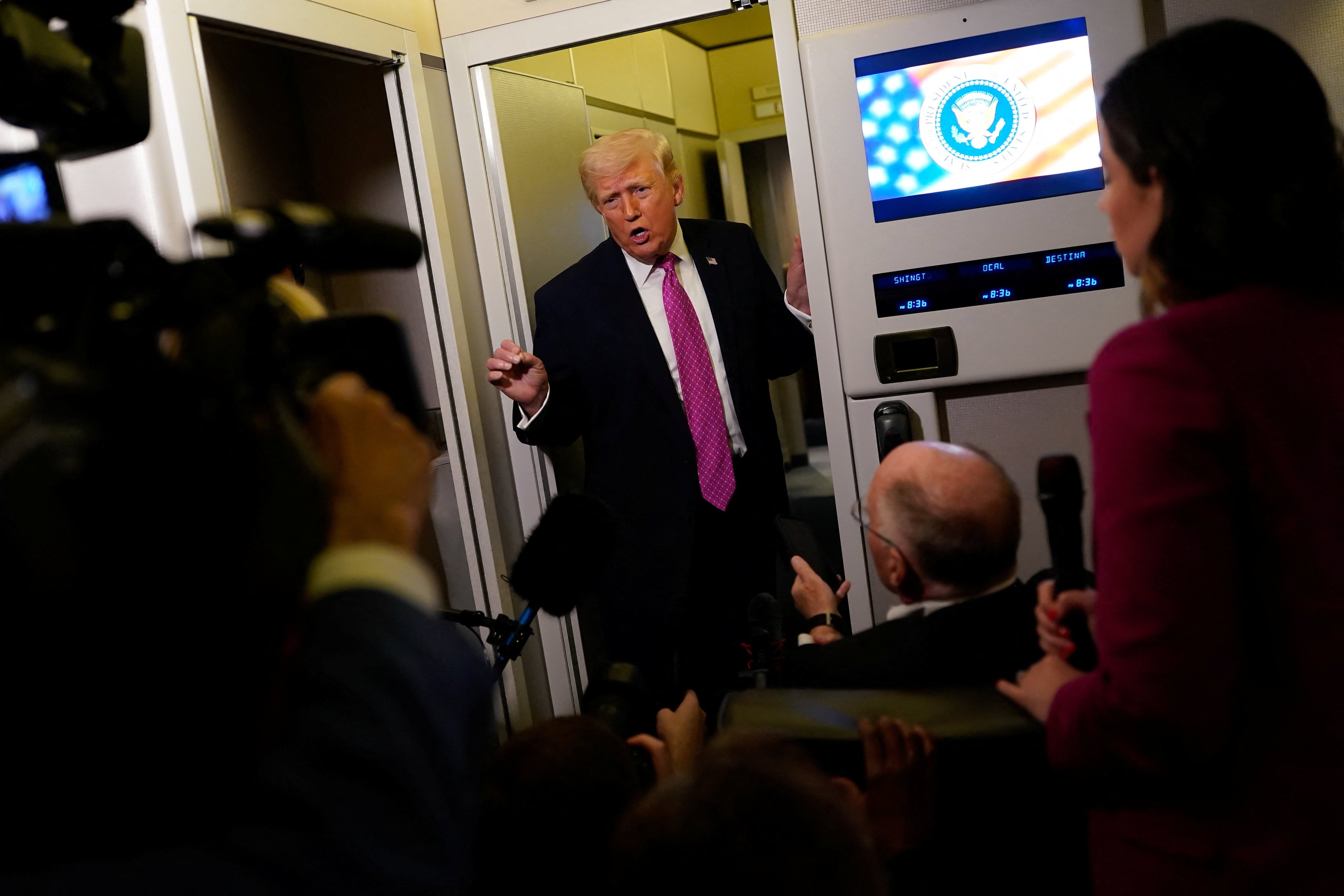 US President Donald Trump talks to the media on board Air Force One on Sunday. Photo: Reuters