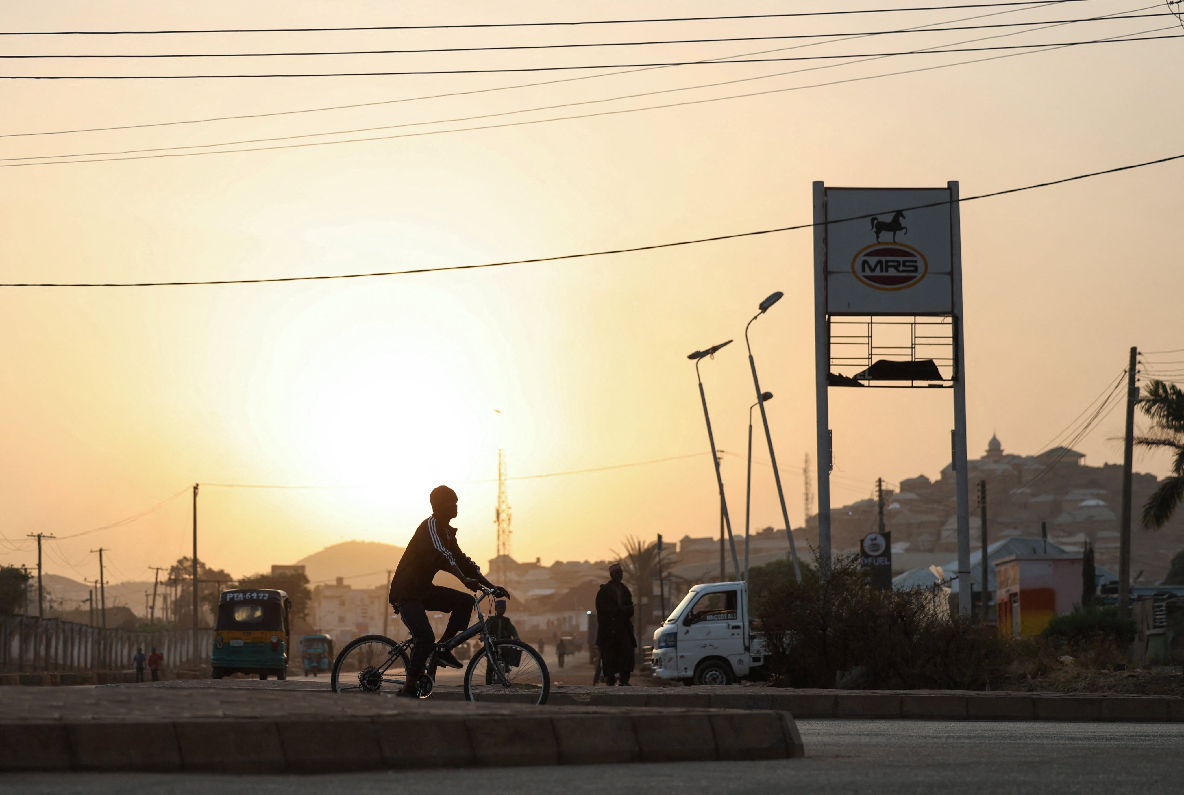 A person rides a bicycle in Jos, Plateau State in Nigeria. Jos has seen bouts of sectarian violence in the past, but deadly, mass casualty attacks in the crowded city have been rare in recent years. Photo: Reuters