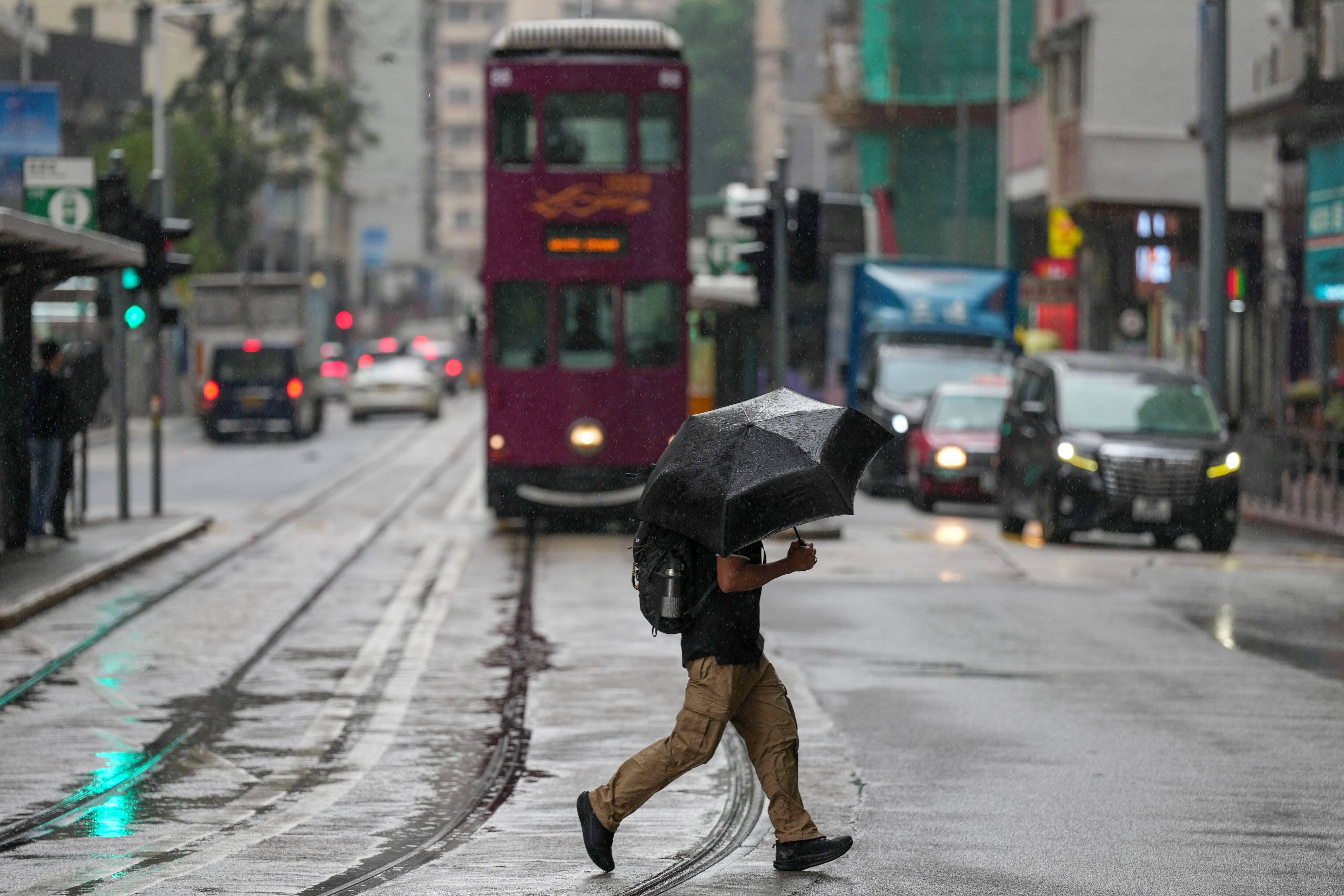 A resident crosses the road in San Wan on Monday morning. Photo: Karma Lo