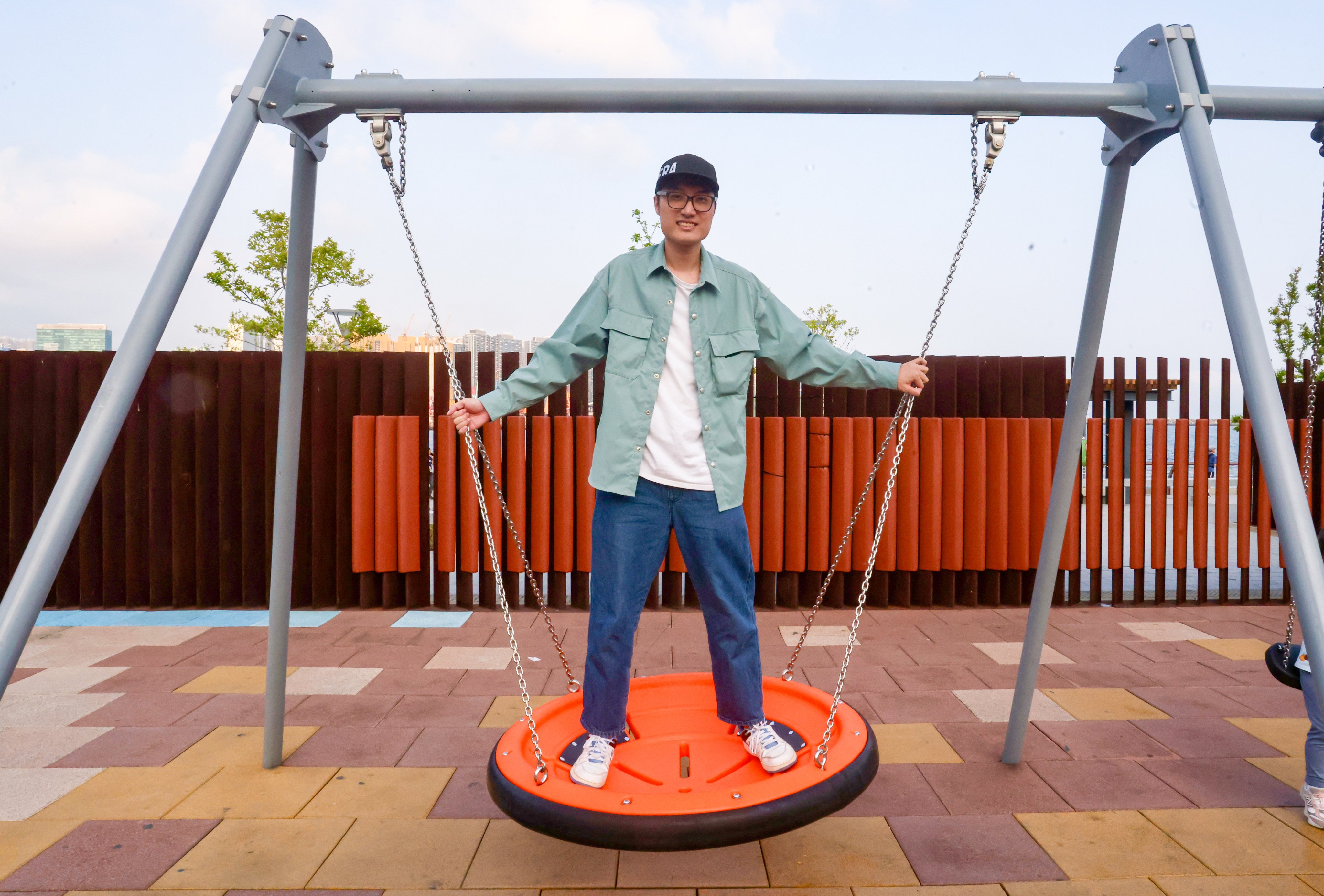 Mr Swing, whose reviews of Hong Kong’s swing sets have seen him accumulate more than 11,000 followers across Instagram, YouTube and Facebook, sits on a swing at Hoi Sham Park at To Kwa Wan on March 24, 2026. Photo: Jonathan Wong