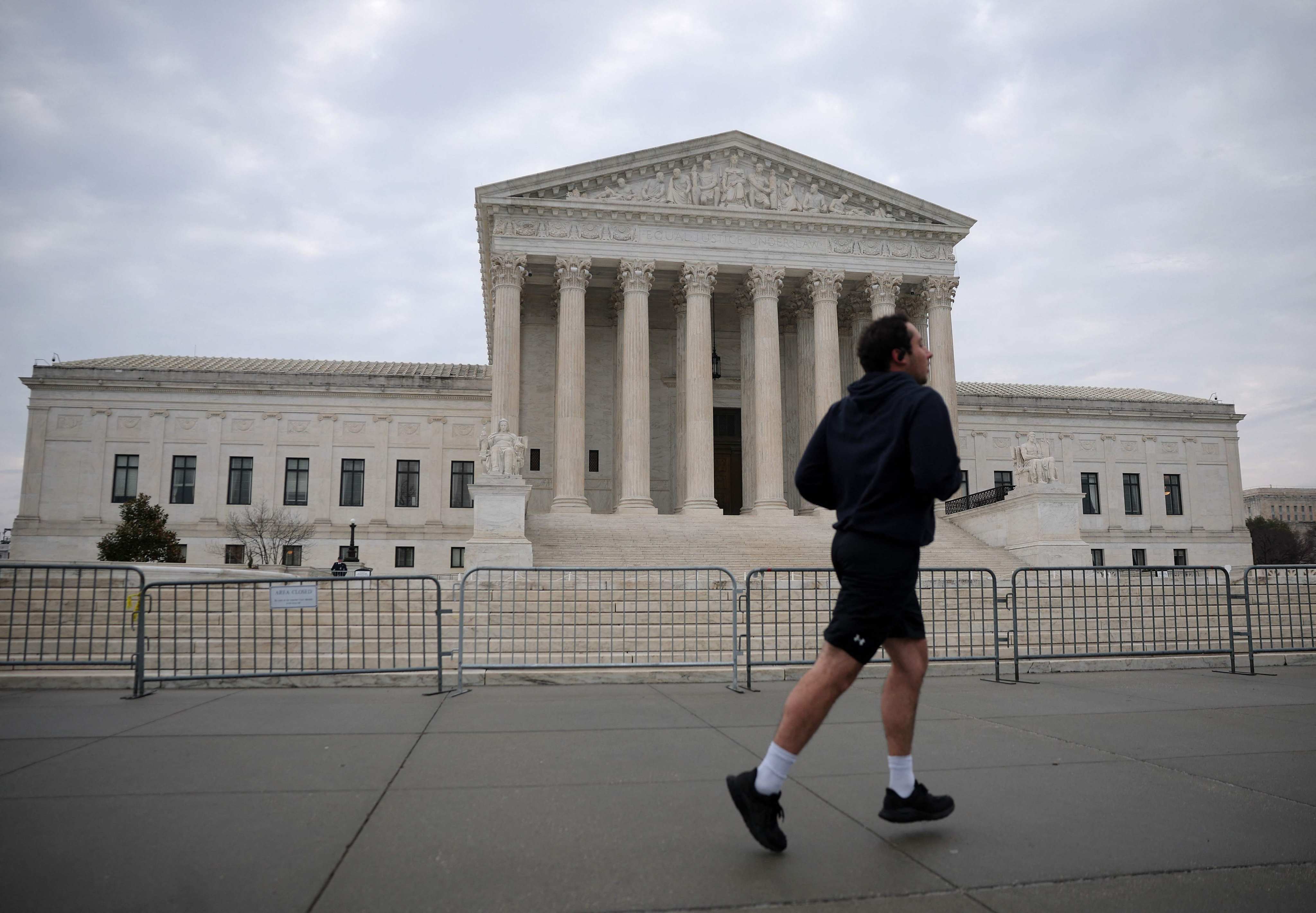 A person jogs in front of the US Supreme Court in Washington, DC. An 8-1 High Court majority sided with a Christian counsellor who argues the law banning talk therapy violates the First Amendment. Photo: Getty Images via AP