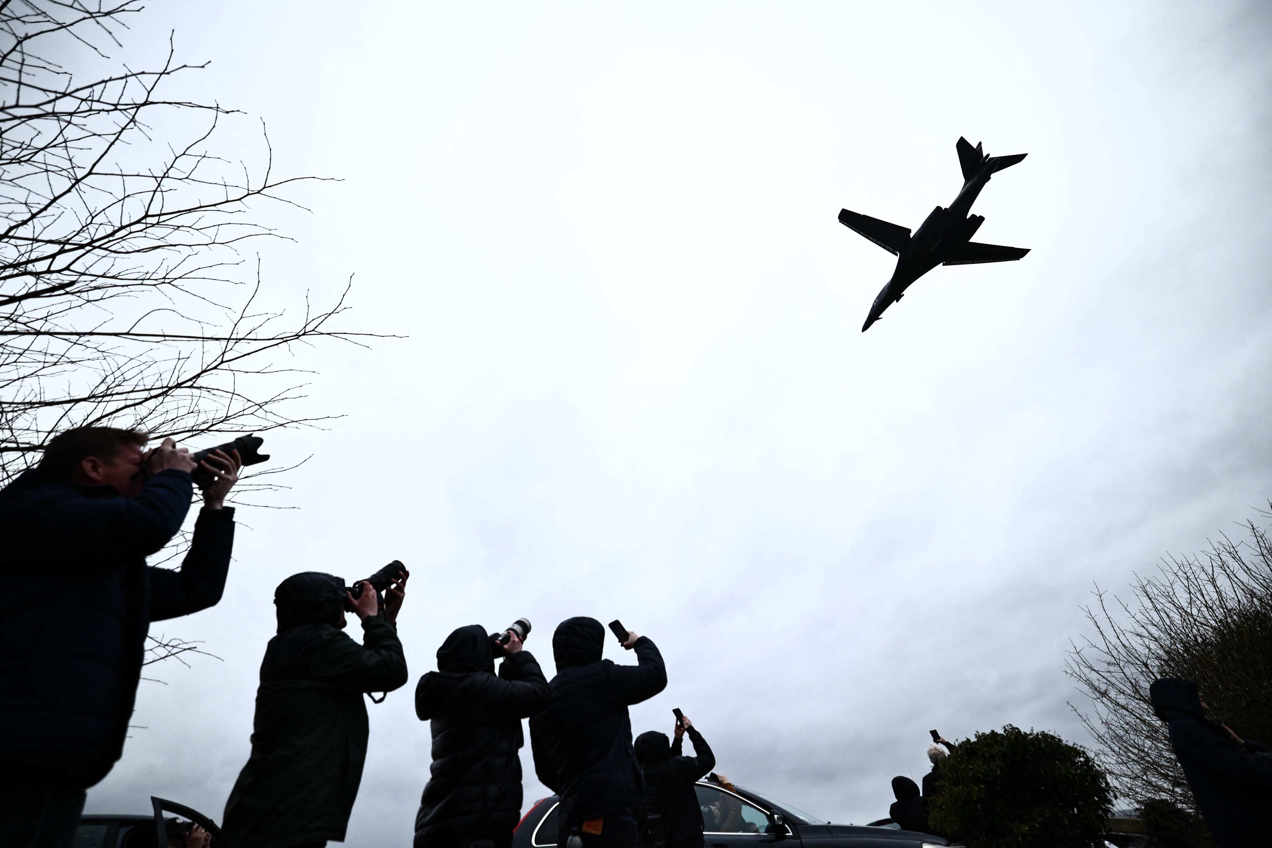 Plane spotters watch a US Air Force B-1 Lancer bomber taking off from a British airbase in Fairford on March 15. Photo: AFP