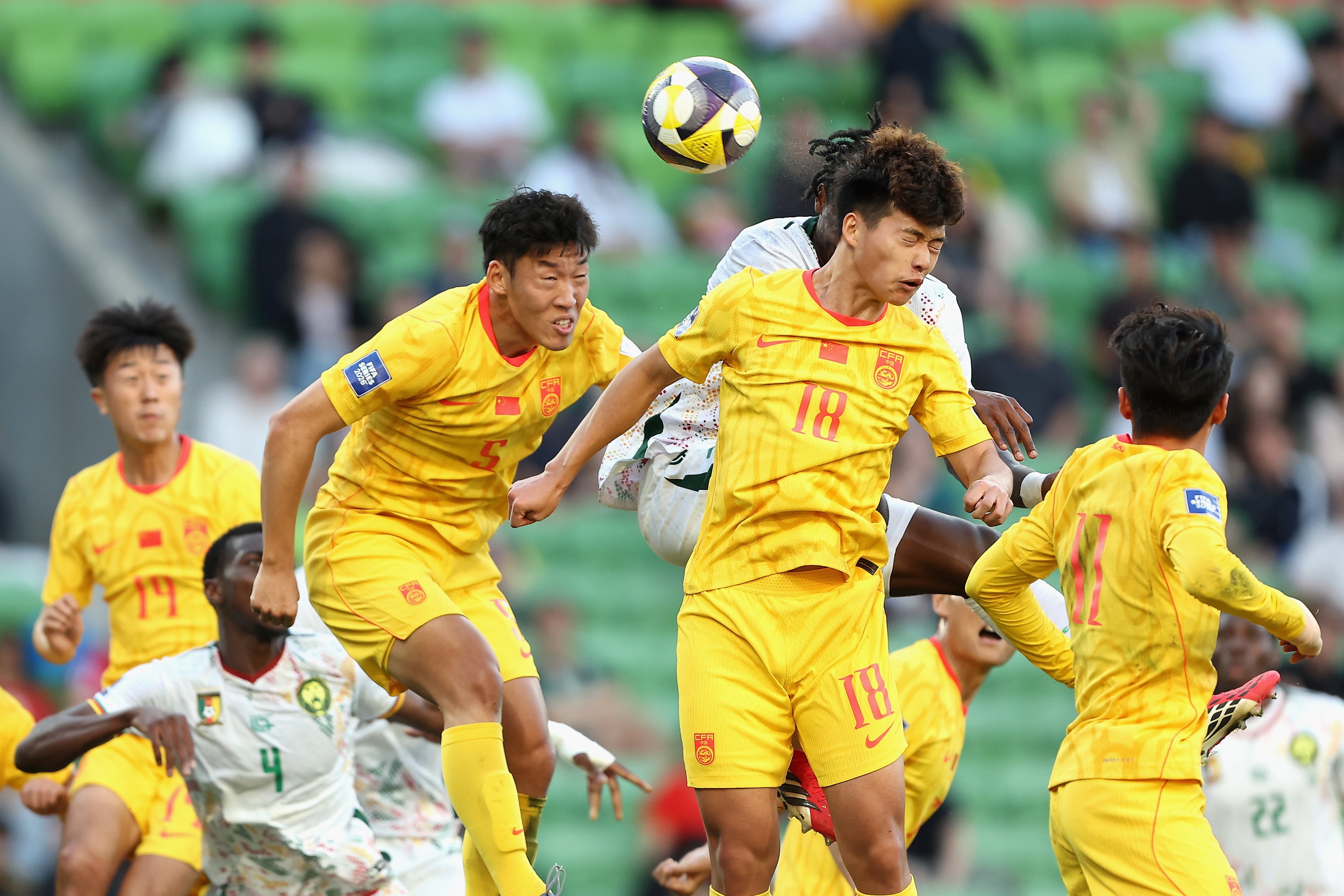 China’s Liu Haofan (left) wins an aerial battle against Cameroon in his team’s loss in a Fifa Series match at AAMI Park in Melbourne on Tuesday. Photo: EPA