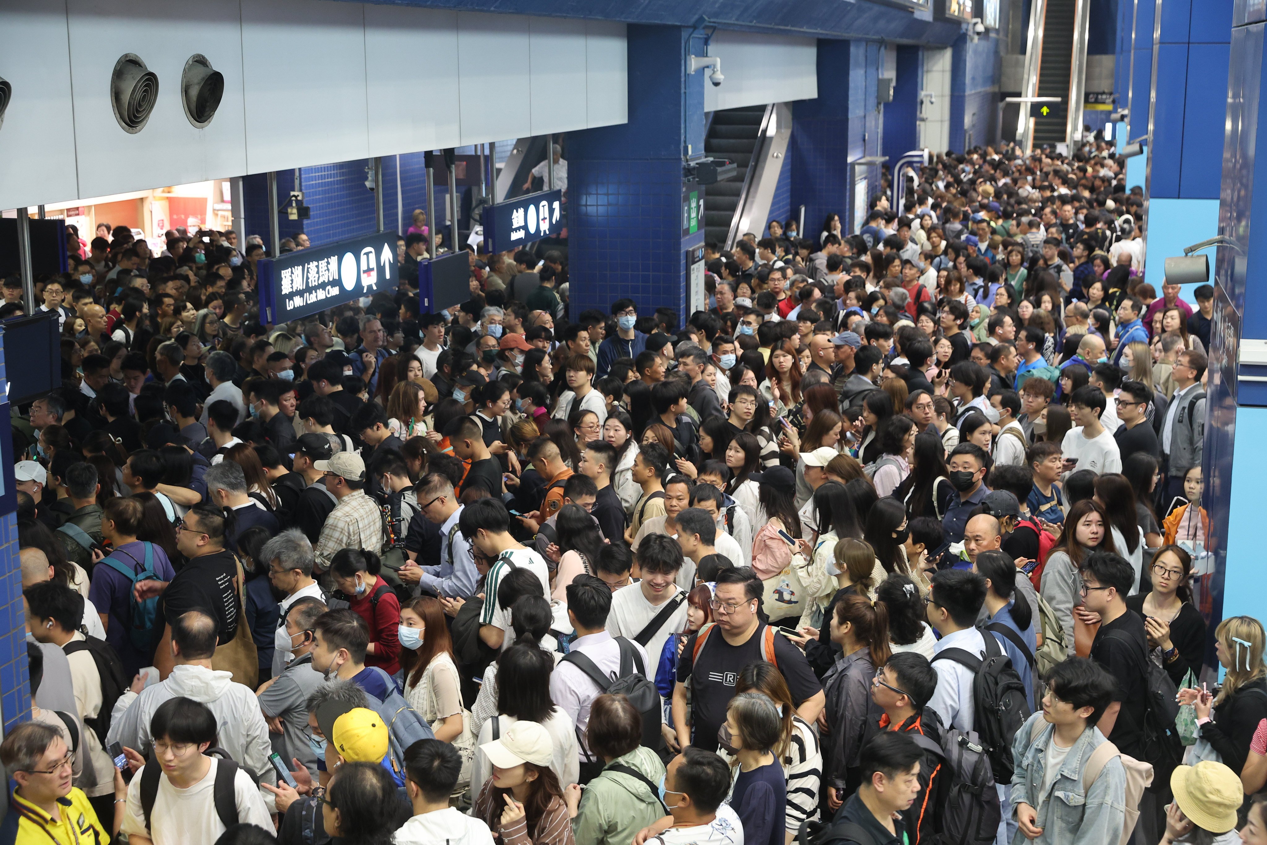 Stranded passengers wait at Tai Wai Station following a suspension of MTR services on the East Rail Line on March 27. A preliminary investigation found that a passenger opened the emergency exit ramp in the rear driver’s cabin of a northbound train that was travelling from Kowloon Tong to Tai Wai station. Photo: Edmond So