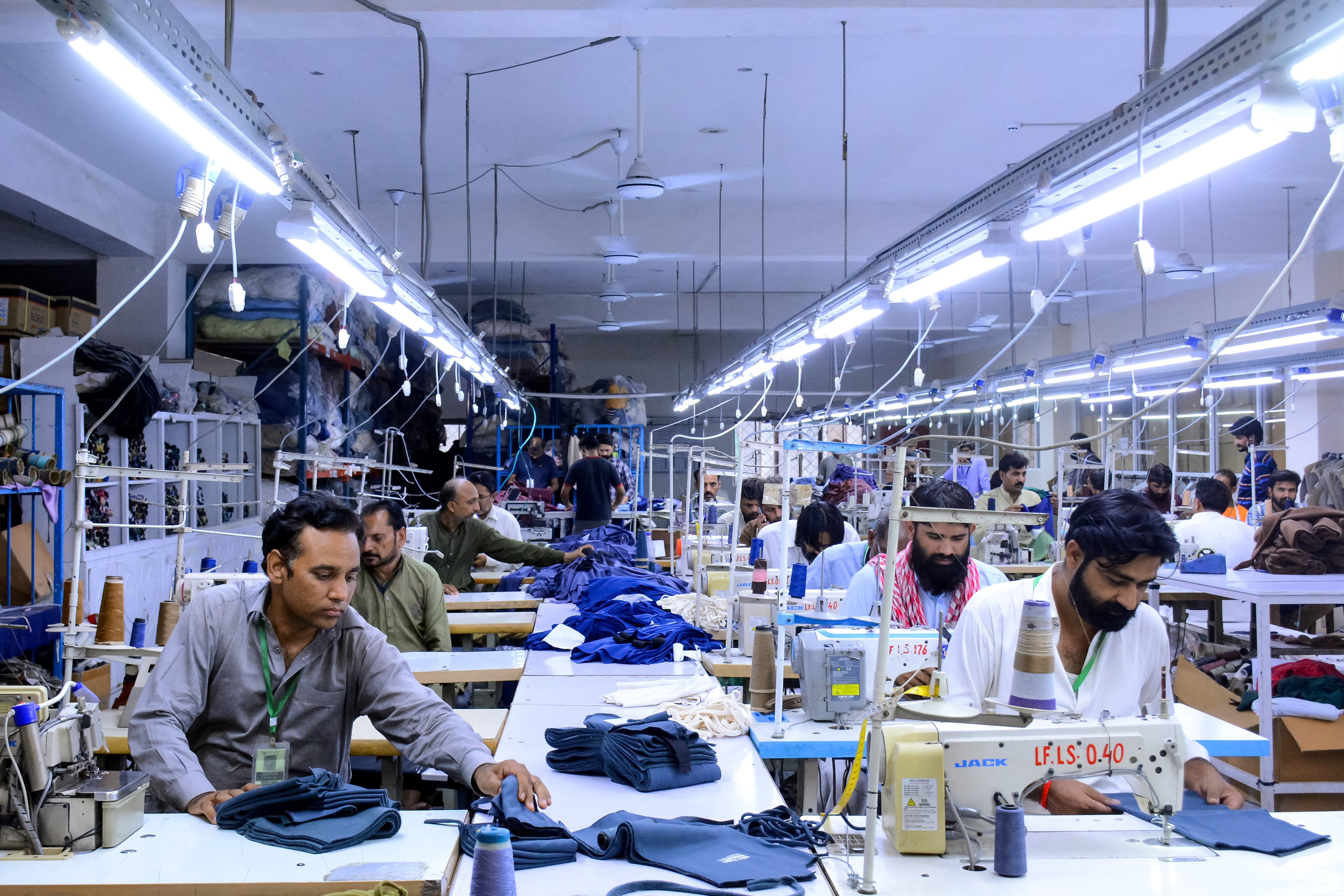 Tailors work at a garment factory in Faisalabad on June 13, 2024. Photo: AFP