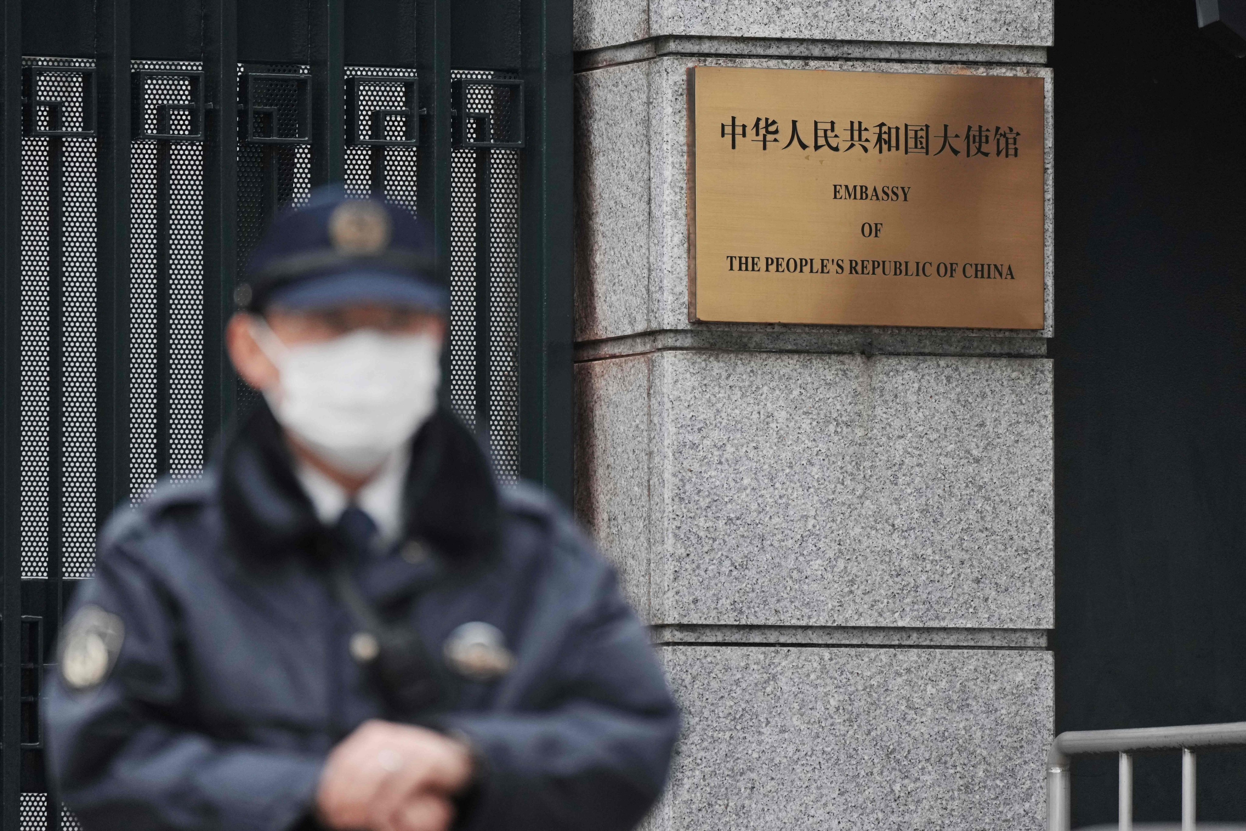 A policeman stands guard at an entrance to the Chinese embassy in Tokyo on March 25. Photo: AFP