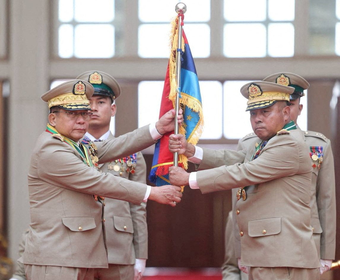 Myanmar junta chief Senior General Min Aung Hlaing hands over a flag to newly appointed Commander-in-Chief General Ye Win Oo at a ceremony in Naypyitaw on Monday. Photo: Handout via Reuters
