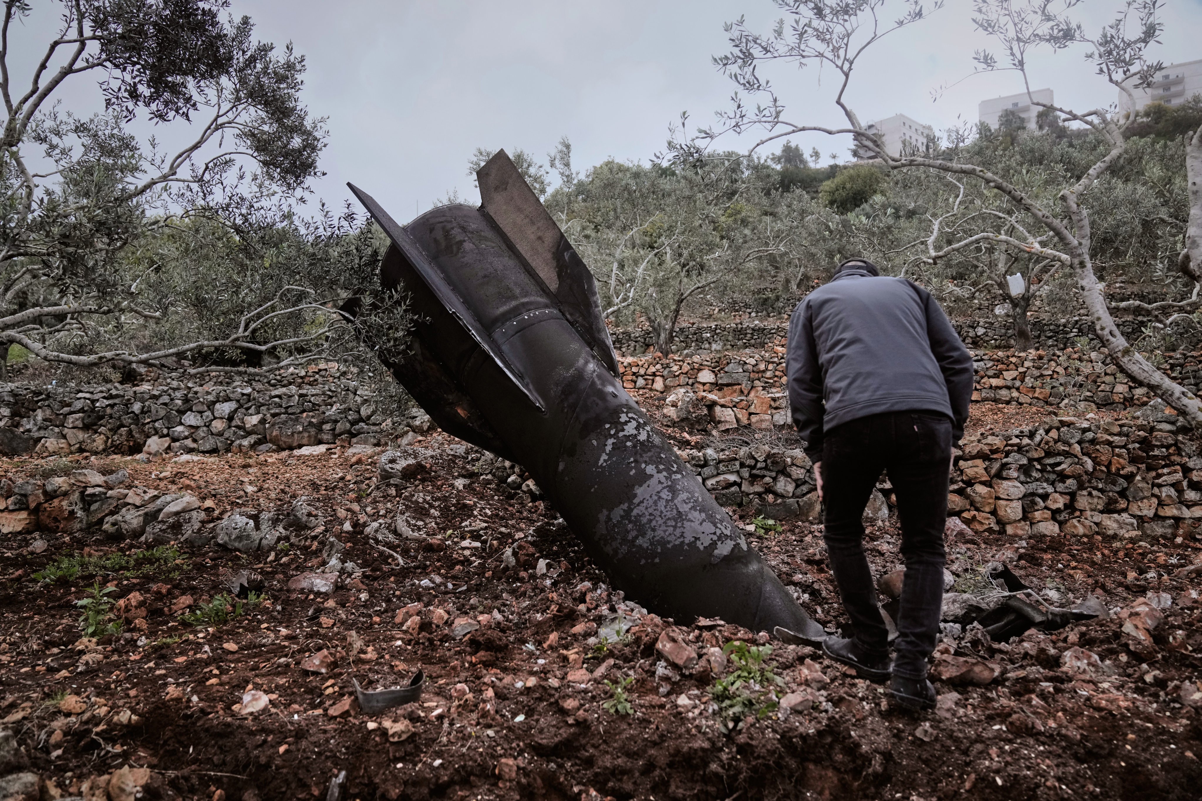 A man inspect the wreckage of an Iranian missile that landed near the West Bank village of Marda on Tuesday. Photo: AP