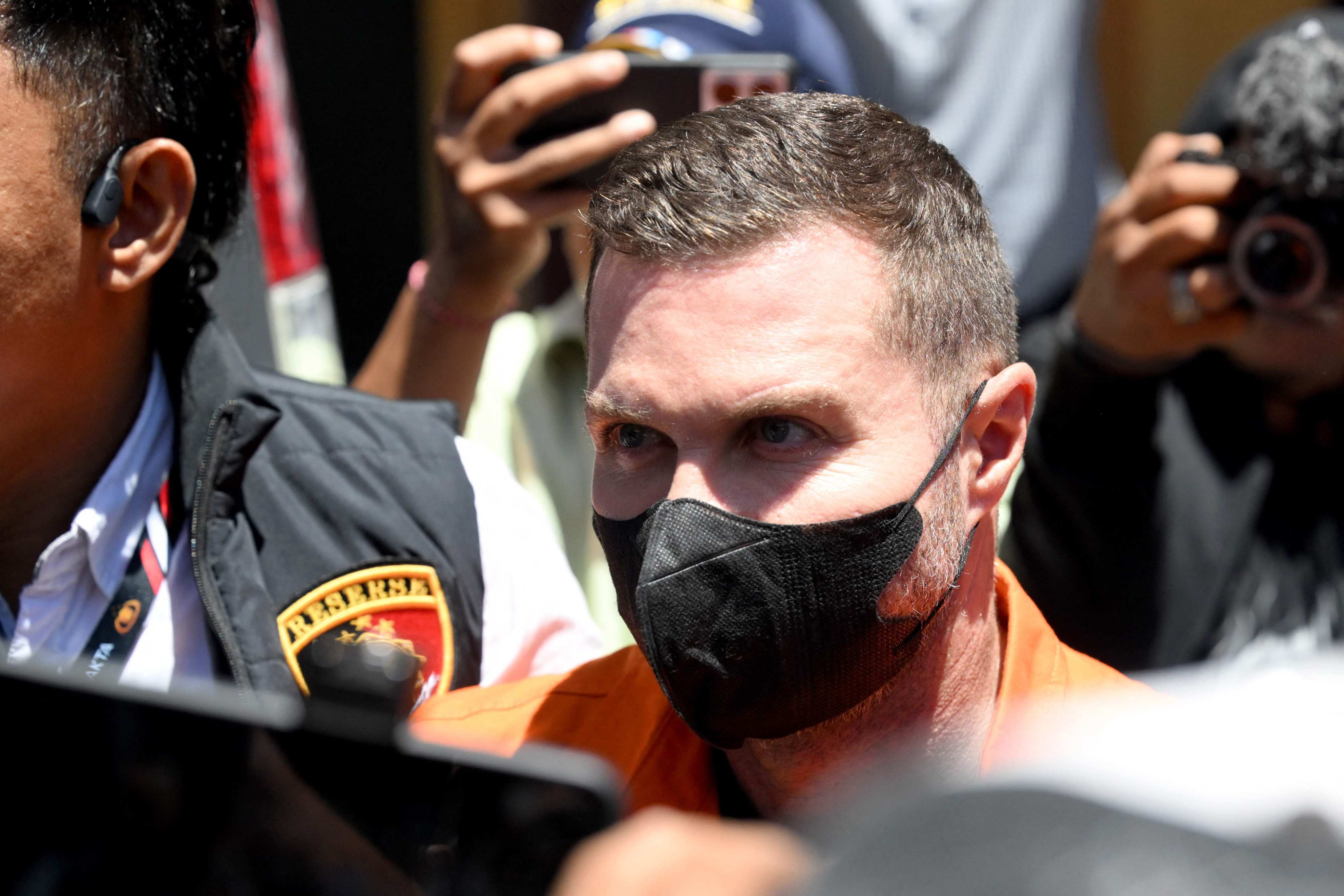 Steven Lyons (centre) is escorted by police officers  in Denpasar, Bali, on Tuesday, Photo: AFP