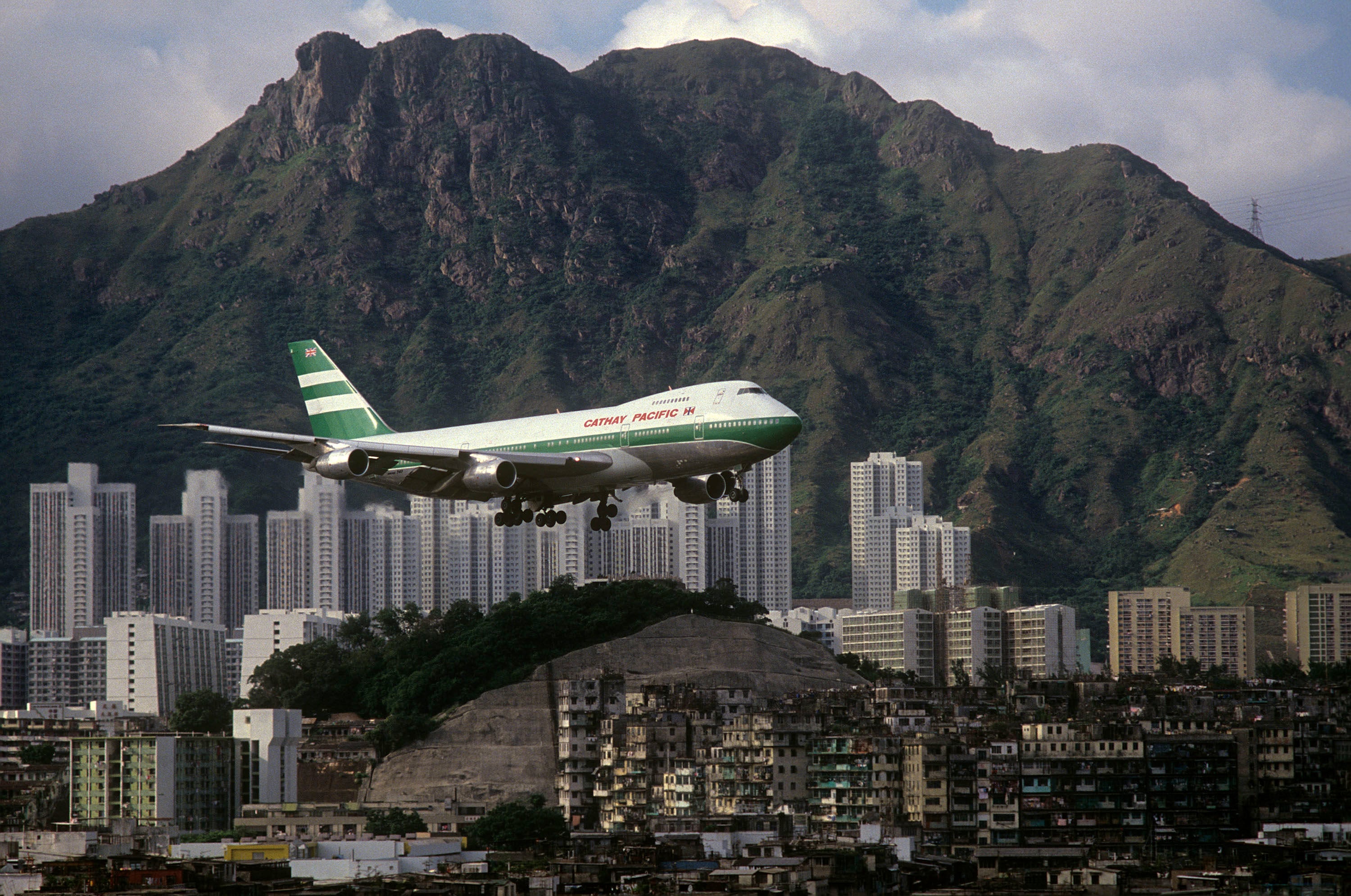 Cathay Pacific 747 with Lion Rock and Kowloon Walled City (1989), by Greg Girard. Photo: courtesy Greg Girard and WKM Gallery