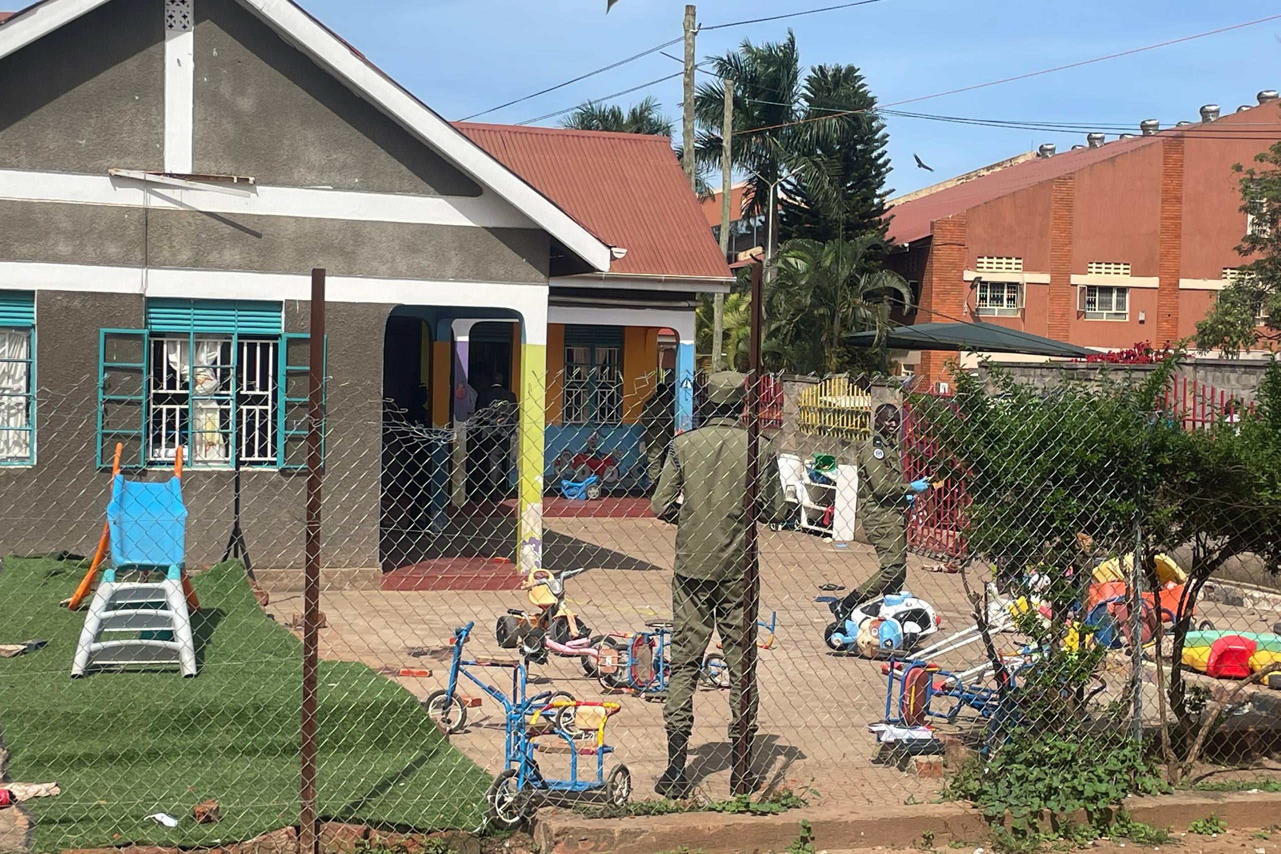 Uganda police officers stand at the crime scene after a man killed four children in a machete attack at the Gaba Early Childhood Development Program nursery school in Kampala, Uganda on Thursday. Photo: AP