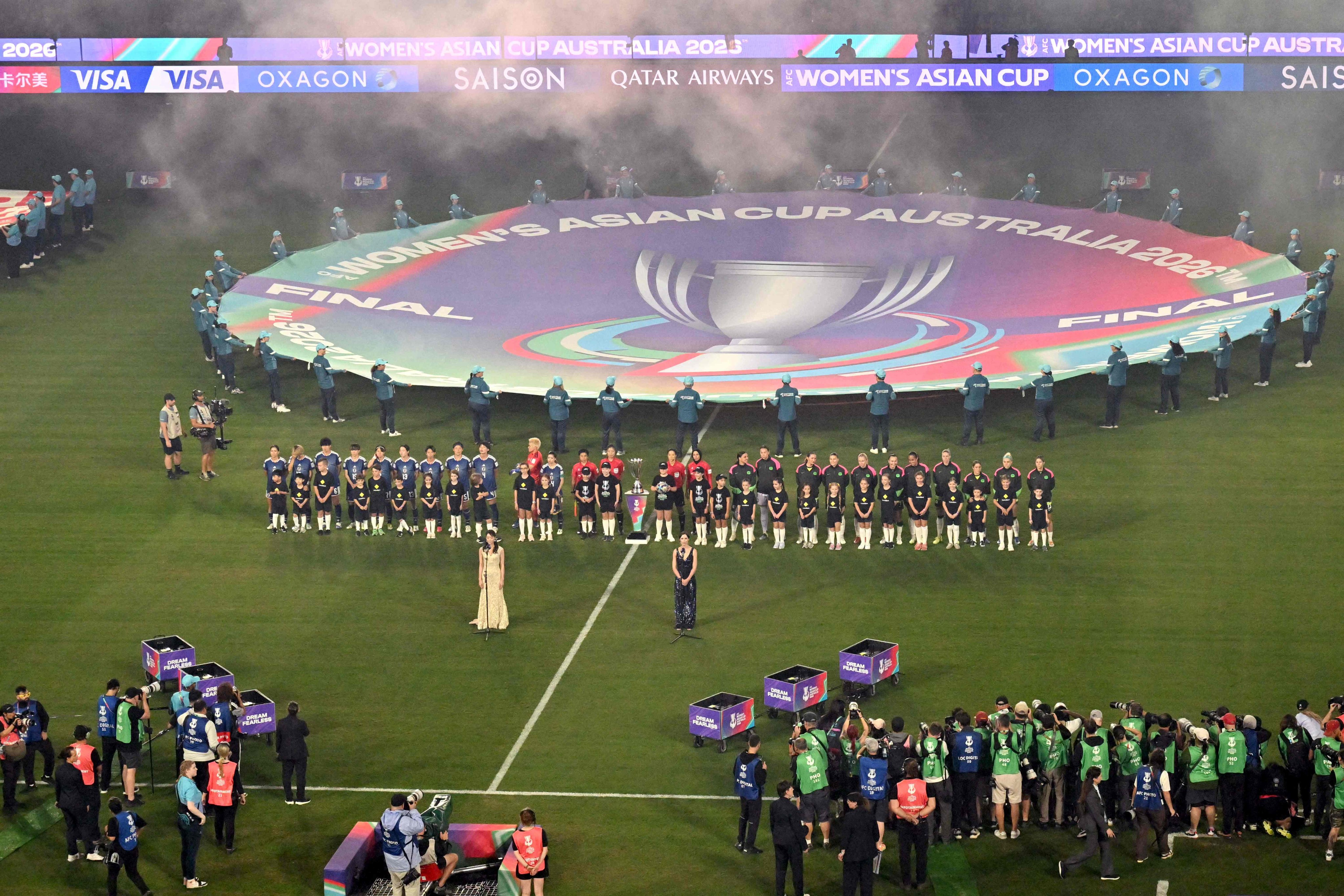 Australia and Japan stand for the national anthems before the final of the AFC Womens Asian Cup tournament last month. Photo: AFP