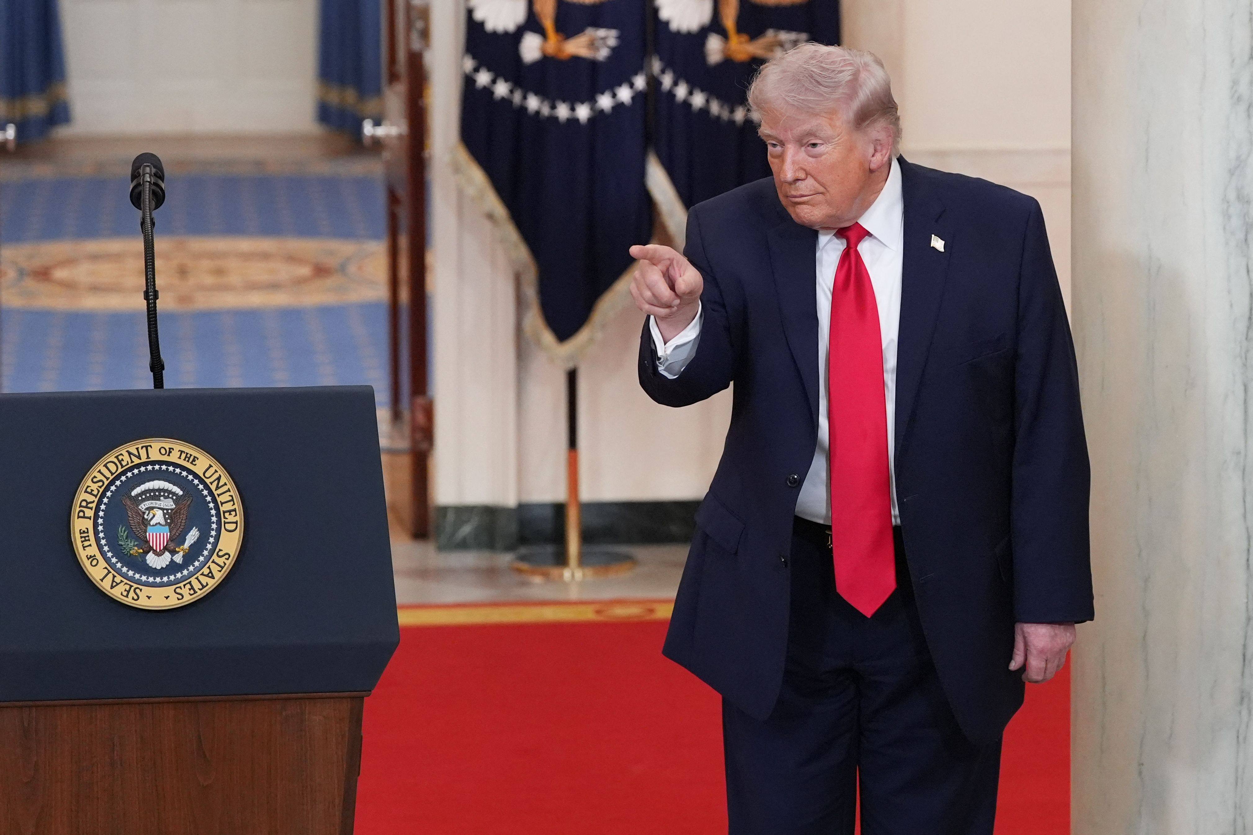 US President Donald Trump points after speaking in a televised address to the nation on the conflict in the Middle East from the Cross Hall of the White House in Washington on April 1. Photo: AFP