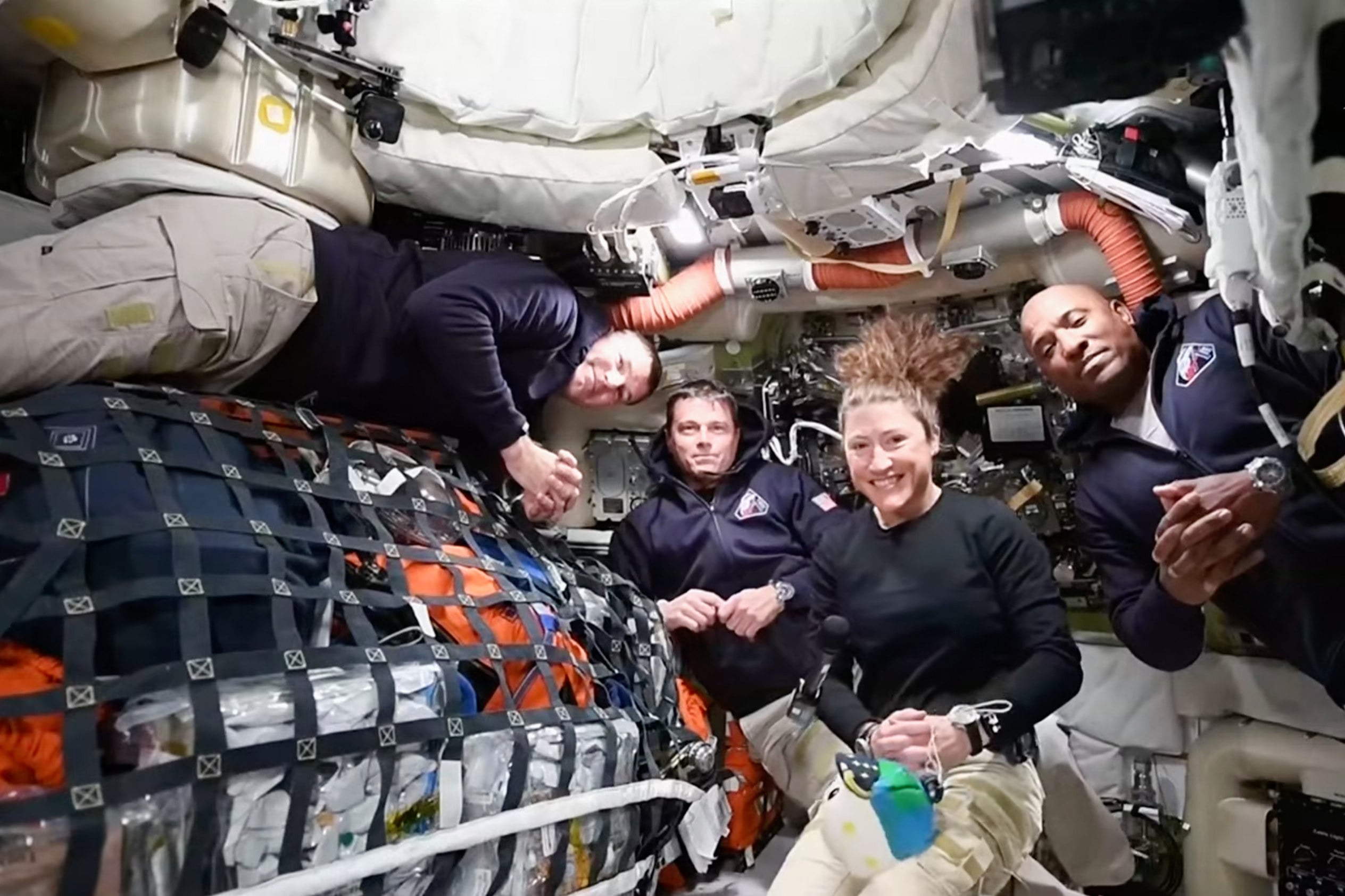 Artemis 2 crew members (from left) Jeremy Hansen, Reid Wiseman, Christina Koch and Victor Glover appear via video link during a mission update on Thursday. Photo: NASA via AP
