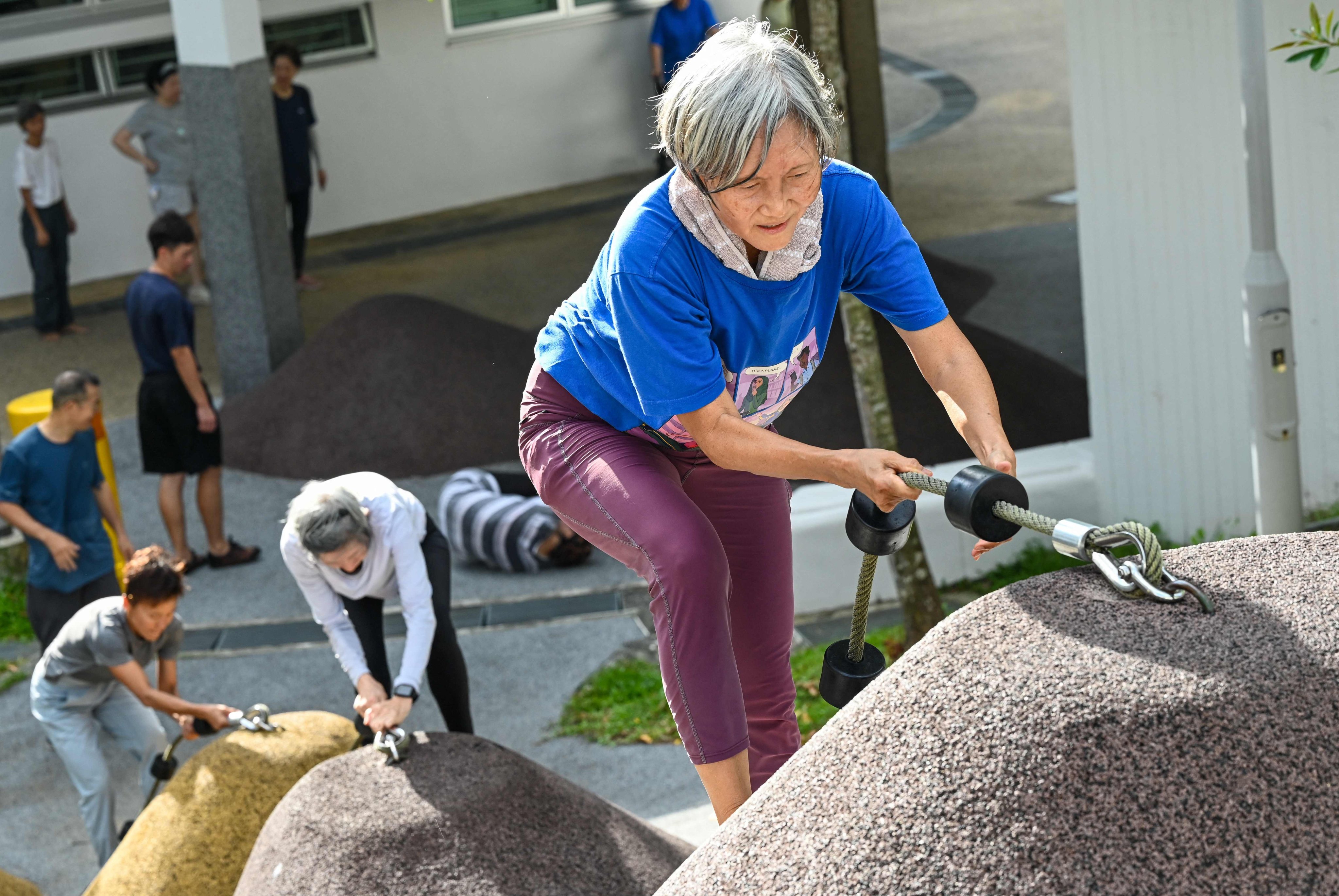 Singaporean seniors take part in a parkour training session, in which around 20 retirees learn to tackle a series of relatively demanding exercises, building their agility and enjoying a sense of camaraderie, on March 17, 2026. Photo: AFP