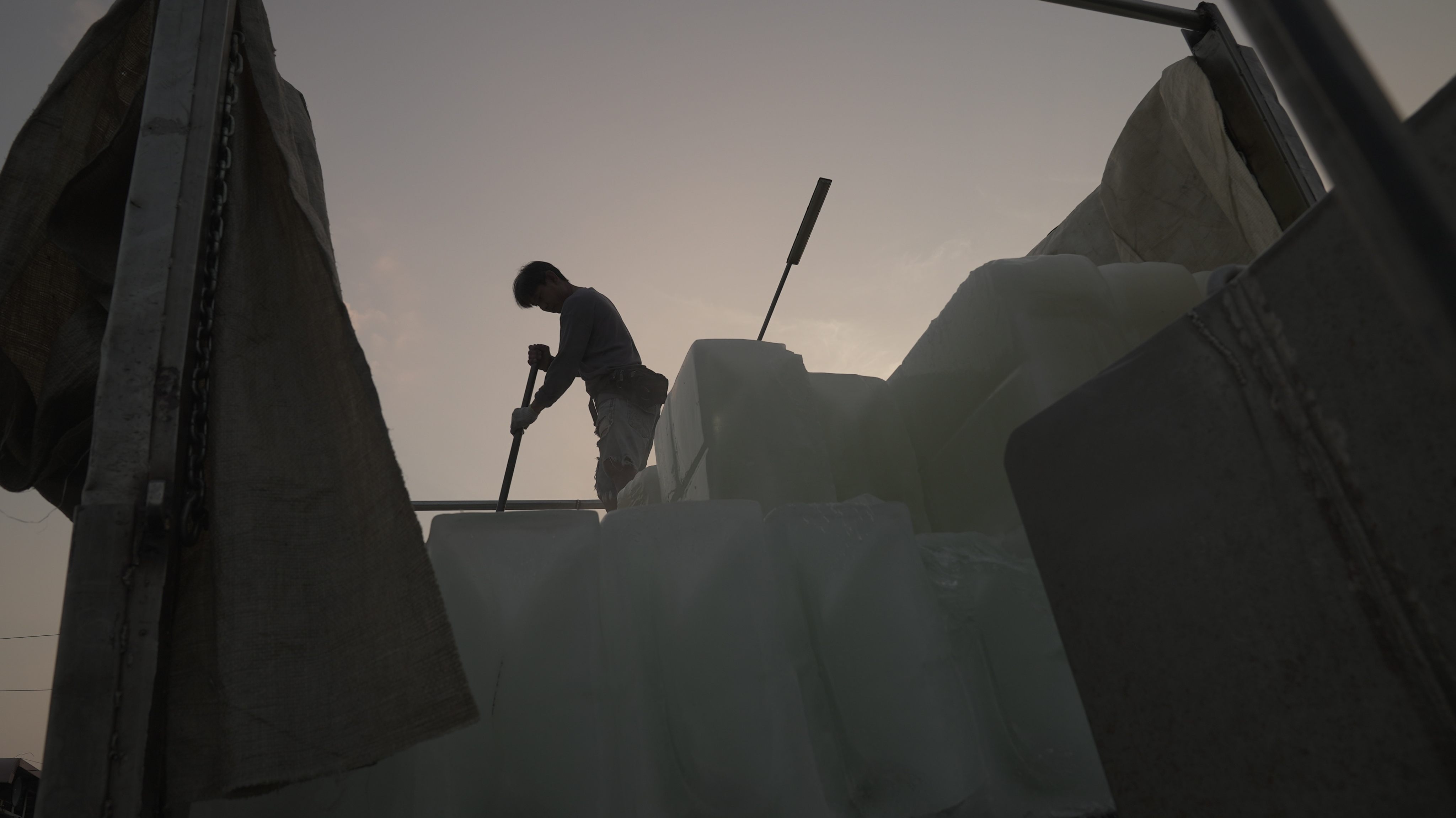 A man on a truck brings the ice that keeps the catch fresh. Photo: Aidan Jones
