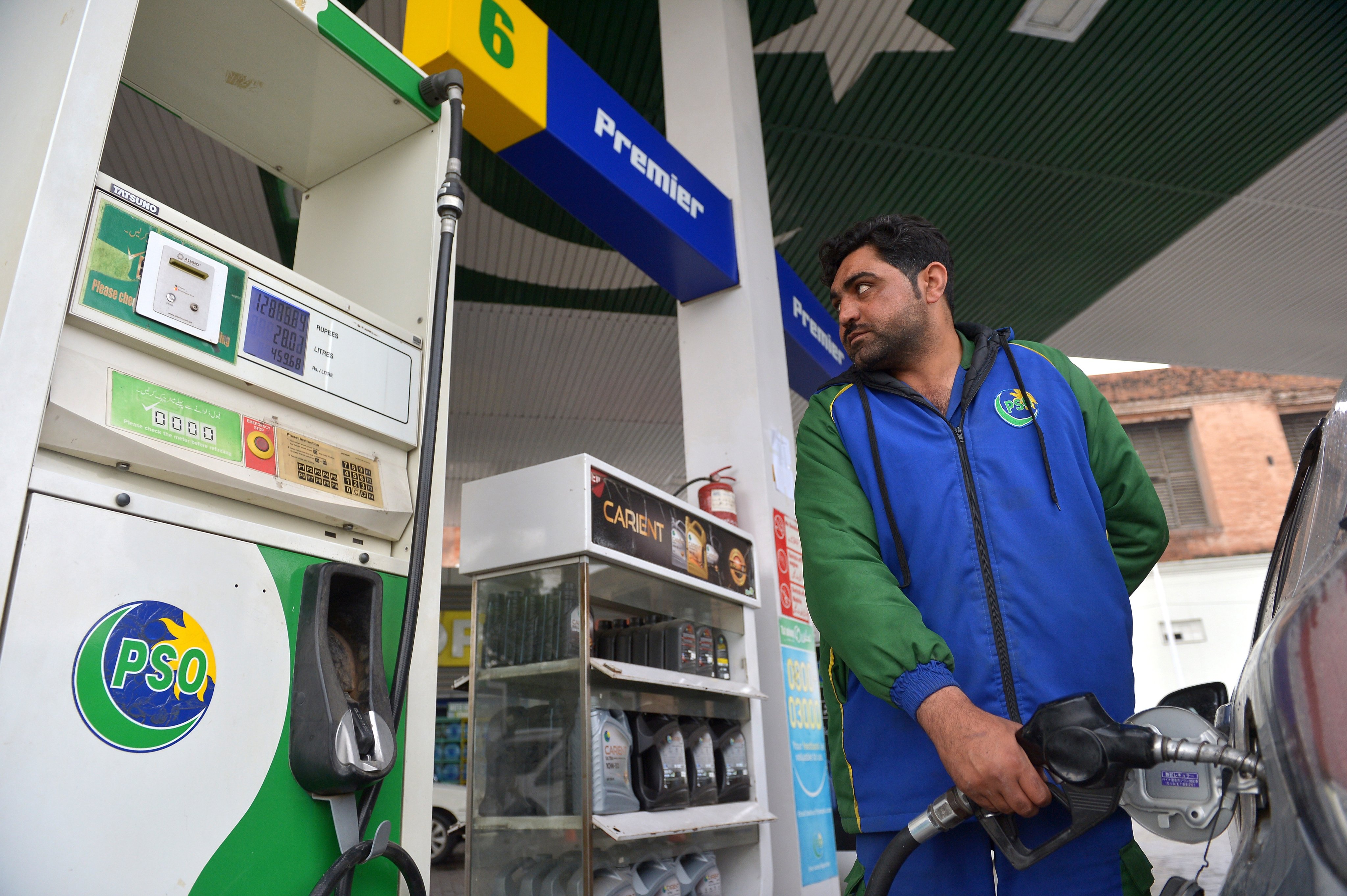 A petrol station worker fills the tank of a vehicle in Peshawar, Pakistan, on Friday. Photo: EPA